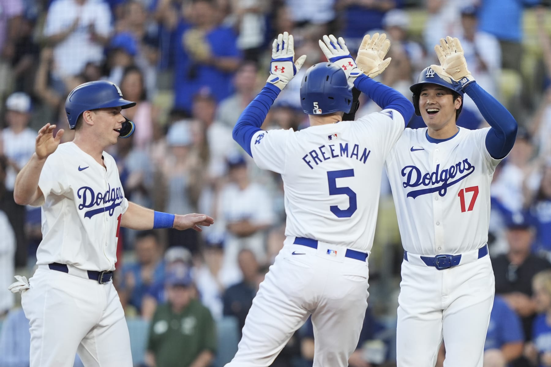 LOS ANGELES, CALIFORNIA - JULY 03: Freddie Freeman #5 of the Los Angeles Dodgers celebrates with his teammates Will Smith #16 and Shohei Ohtani #17 after hitting a three run home run during the first inning of a game between the Los Angeles Dodgers and the Arizona Diamondbacks at Dodger Stadium on July 03, 2024 in Los Angeles, California. (Photo by Michael Owens/Getty Images)