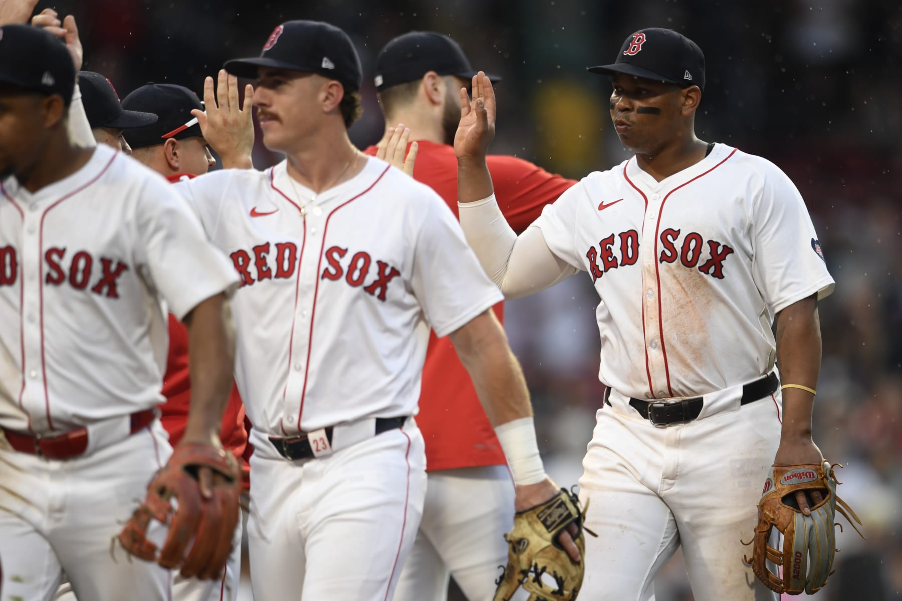 BOSTON, MASSACHUSETTS - JUNE 30: Rafael Devers #11 of the Boston Red Sox high-fives his teammates after their ninth inning win over the San Diego Padres at Fenway Park on June 30, 2024 in Boston, Massachusetts. (Photo by Jaiden Tripi/Getty Images)