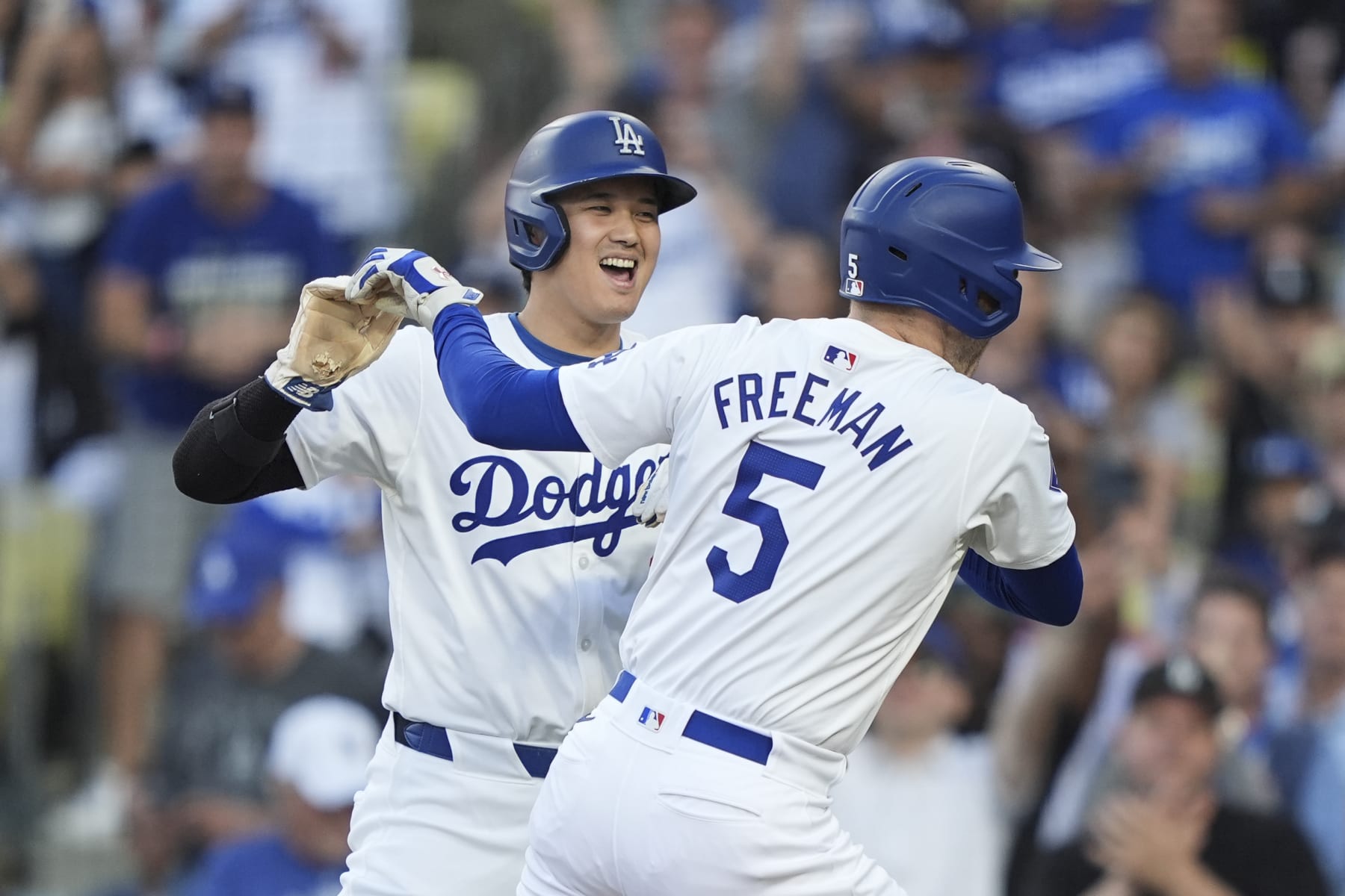 LOS ANGELES, CALIFORNIA - JULY 03: Freddie Freeman #5 of the Los Angeles Dodgers celebrates with his teammate Shohei Ohtani #17 after hitting a three run home run during the first inning of a game between the Los Angeles Dodgers and the Arizona Diamondbacks at Dodger Stadium on July 03, 2024 in Los Angeles, California. (Photo by Michael Owens/Getty Images)