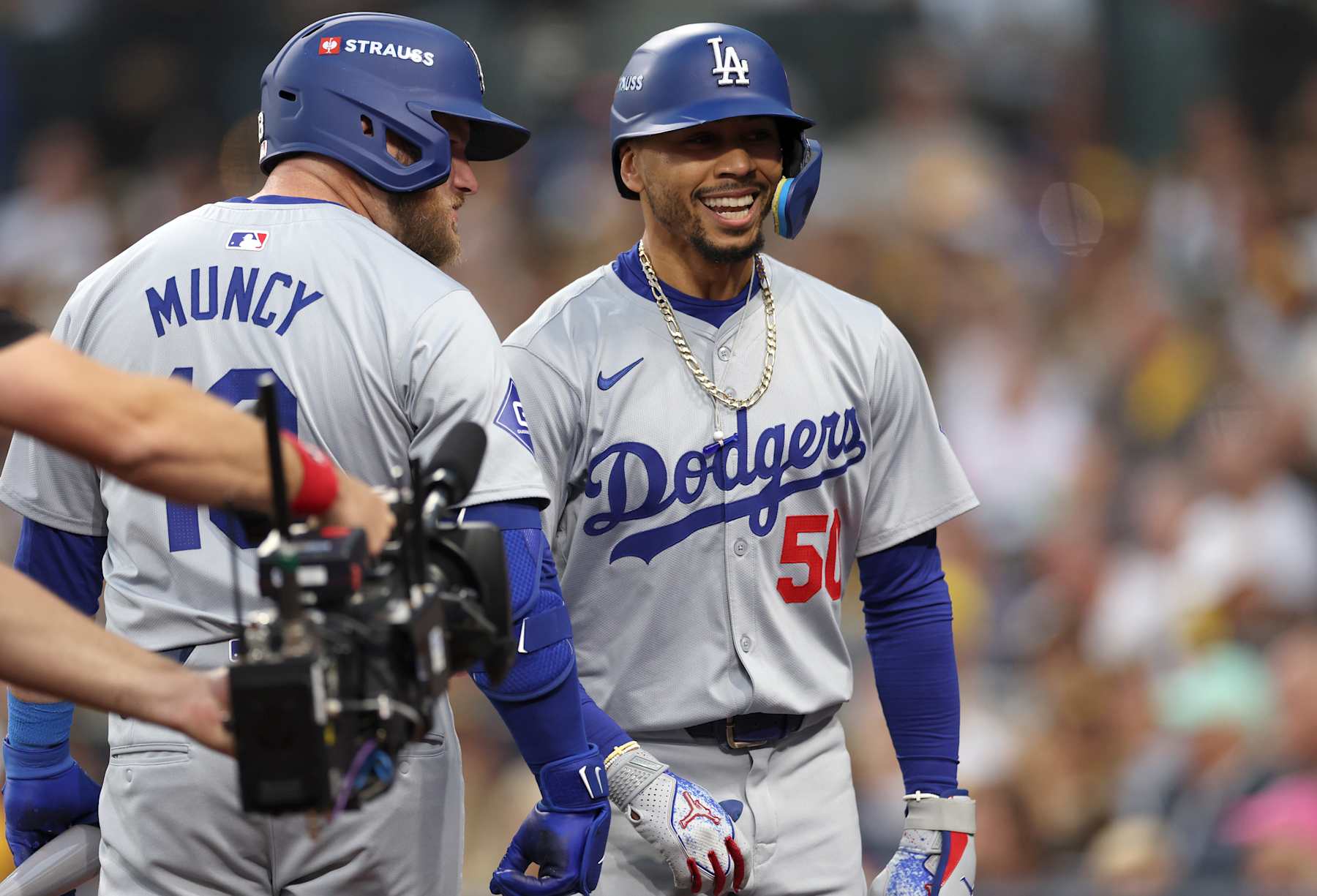 SAN DIEGO, CALIFORNIA - OCTOBER 09:  Mookie Betts #50 of the Los Angeles Dodgers celebrates after hitting a home run with Max Muncy #13 in the first inning against the San Diego Padres during Game Four of the Division Series at Petco Park on October 09, 2024 in San Diego, California. (Photo by Harry How/Getty Images)