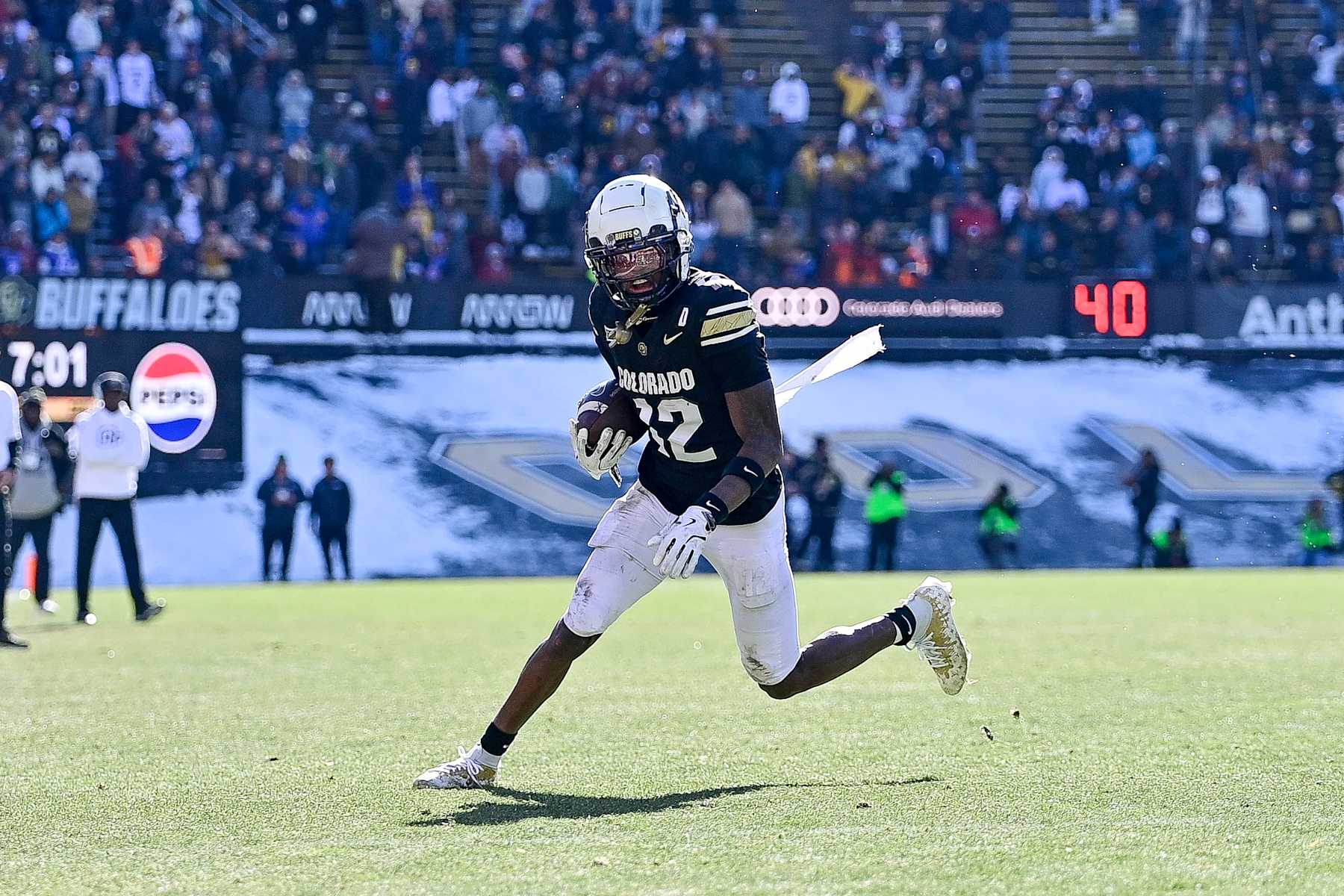 BOULDER, CO - NOVEMBER 29: Travis Hunter #12 of the Colorado Buffaloes runs against the Oklahoma State Cowboys after a catch in the third quarter at Folsom Field on November 29, 2024 in Boulder, Colorado. (Photo by Dustin Bradford/Getty Images) BOULDER, CO - NOVEMBER 29: Travis Hunter #12 of the Colorado Buffaloes runs against the Oklahoma State Cowboys after a catch in the third quarter at Folsom Field on November 29, 2024 in Boulder, Colorado. (Photo by Dustin Bradford/Getty Images)