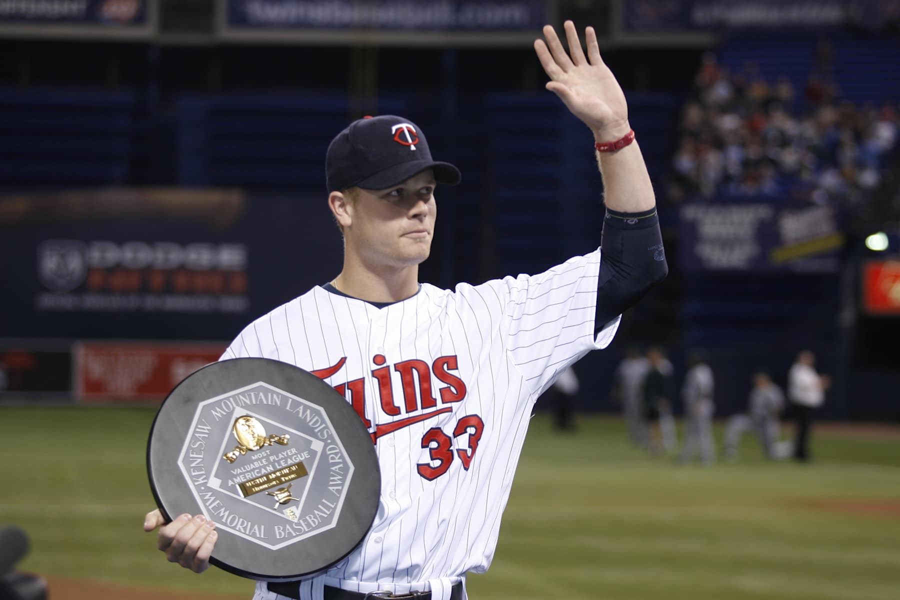 MINNEAPOLIS - APRIL 13:  Justin Morneau of the Minnesota Twins acknowledges the crowd with his 2006 American League Most Valuable Player Award in a pre-game ceremony prior to the game against the Tampa Bay Devil Rays at the Humphrey Metrodome in Minneapolis, Minnesota on April 13, 2007.  The Devil Rays defeated the Twins 4-2.  (Photo by Bruce Kluckhohn/MLB Photos via Getty Images) 