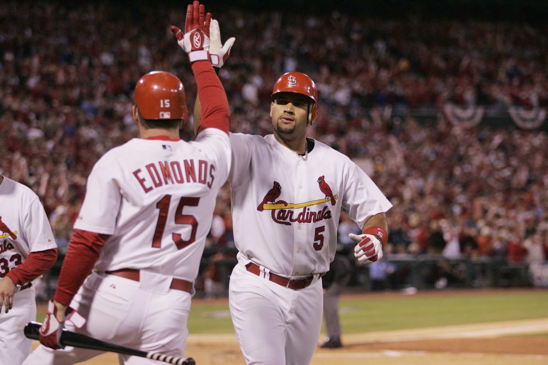 ST. LOUIS - OCTOBER 13:  Albert Pujols is congratulated by Jim Edmonds of the St. Louis Cardinals after hitting a home run during the first inning of game one of the NLCS against the Houston Astros at Busch Stadium on October 13, 2004 in St. Louis, Missouri. The Cards defeated the Astros 10-7. (Photo by Rich Pilling/MLB via Getty Images)