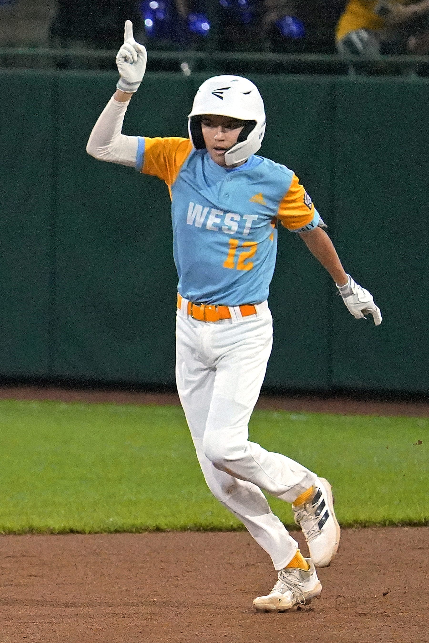 Honolulu's Daly Watson (12) celebrates as he rounds the bases after hitting a two-run home run during the first inning of a baseball game Pearland, Texas, at the Little League World Series in South Williamsport, Pa., Monday, Aug. 22, 2022. (AP Photo/Gene J. Puskar)