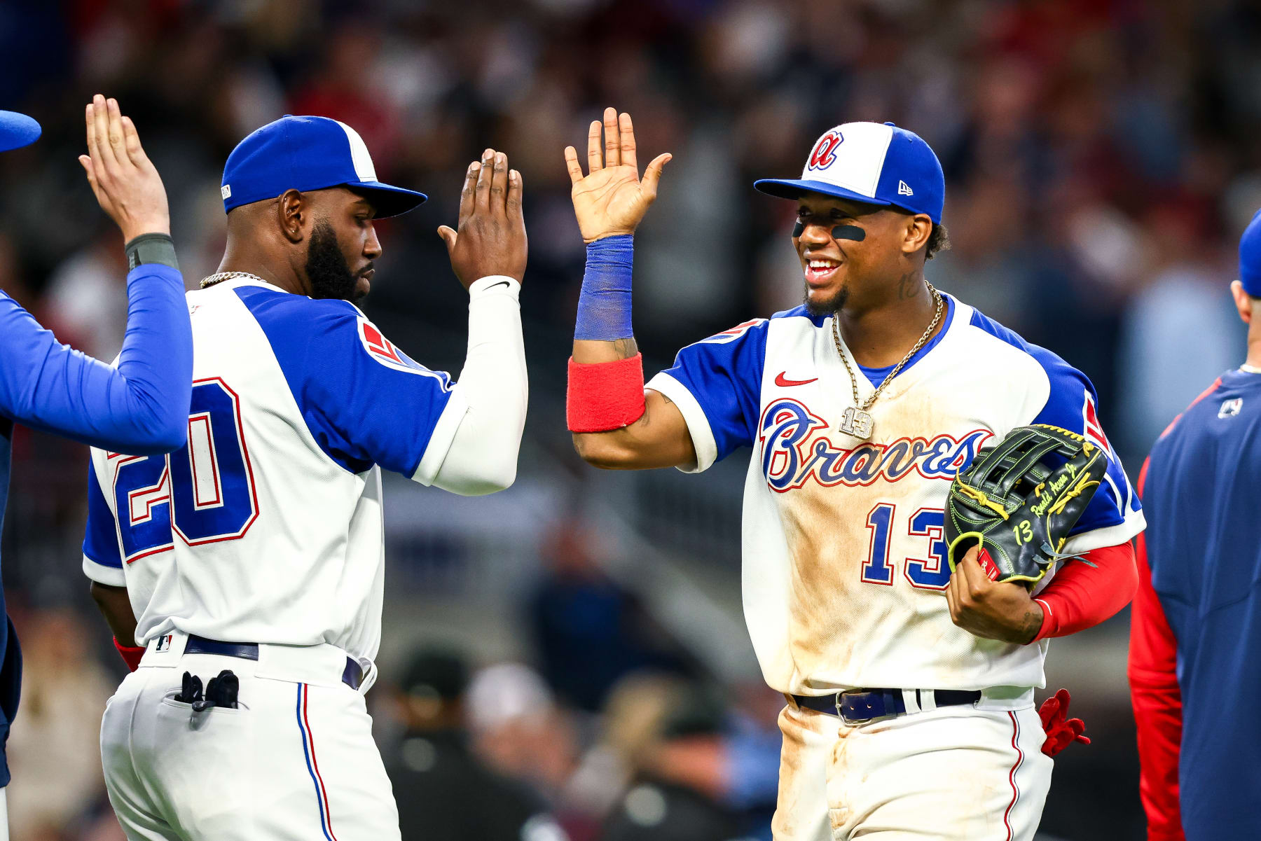 ATLANTA, GA - MAY 07: Ronald Acuña Jr. #13 of the Atlanta Braves celebrates with teammates after a 3-2 victory over the Milwaukee Brewers at Truist Park on May 7, 2022 in Atlanta, Georgia. (Photo by Casey Sykes/Getty Images)