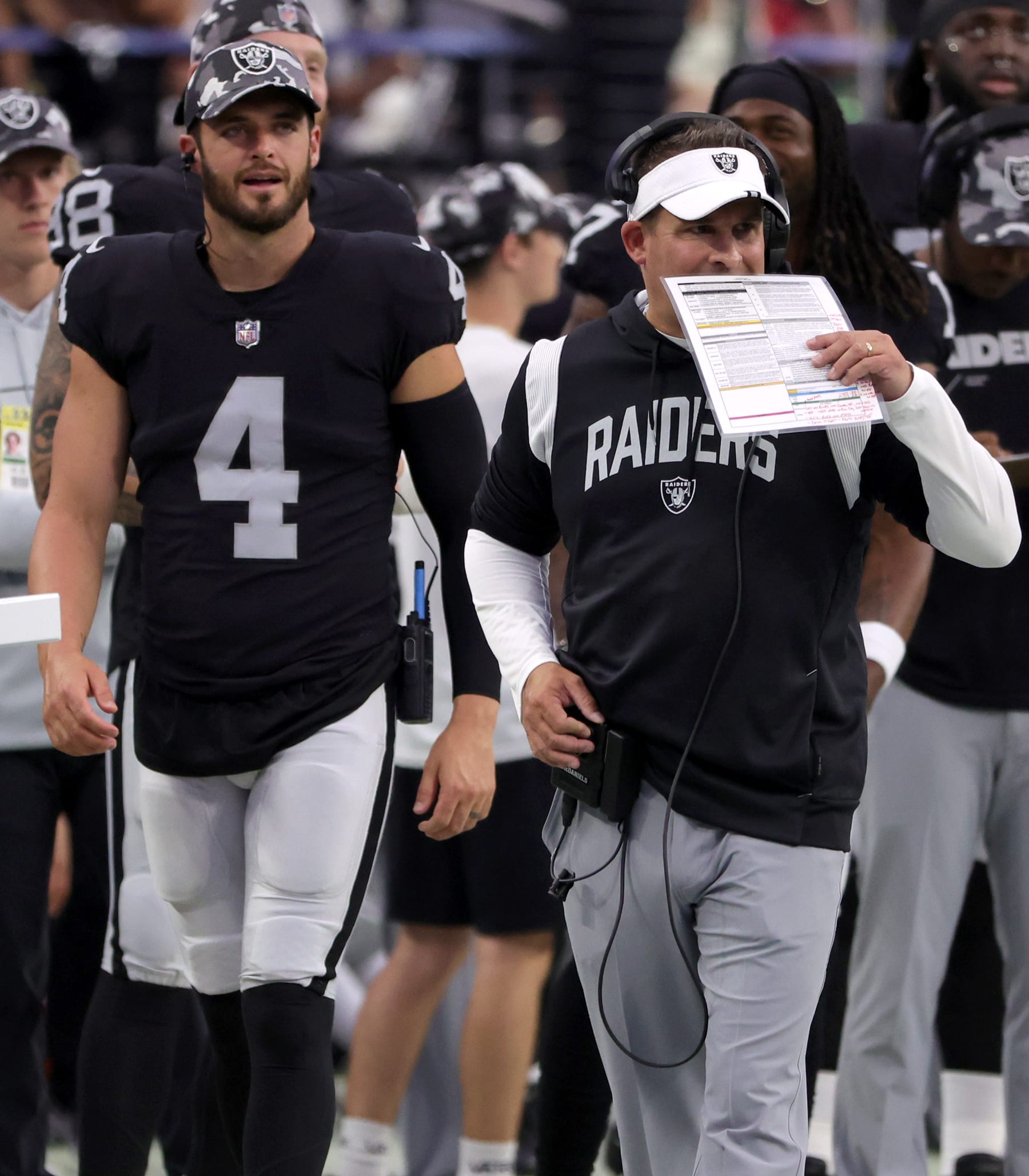 LAS VEGAS, NEVADA - AUGUST 14: Quarterback Derek Carr #4 of the Las Vegas Raiders looks on as head coach Josh McDaniels speaks during a preseason game against the Minnesota Vikings at Allegiant Stadium on August 14, 2022 in Las Vegas, Nevada. The Raiders defeated Vikings the 26-20. (Photo by Ethan Miller/Getty Images)