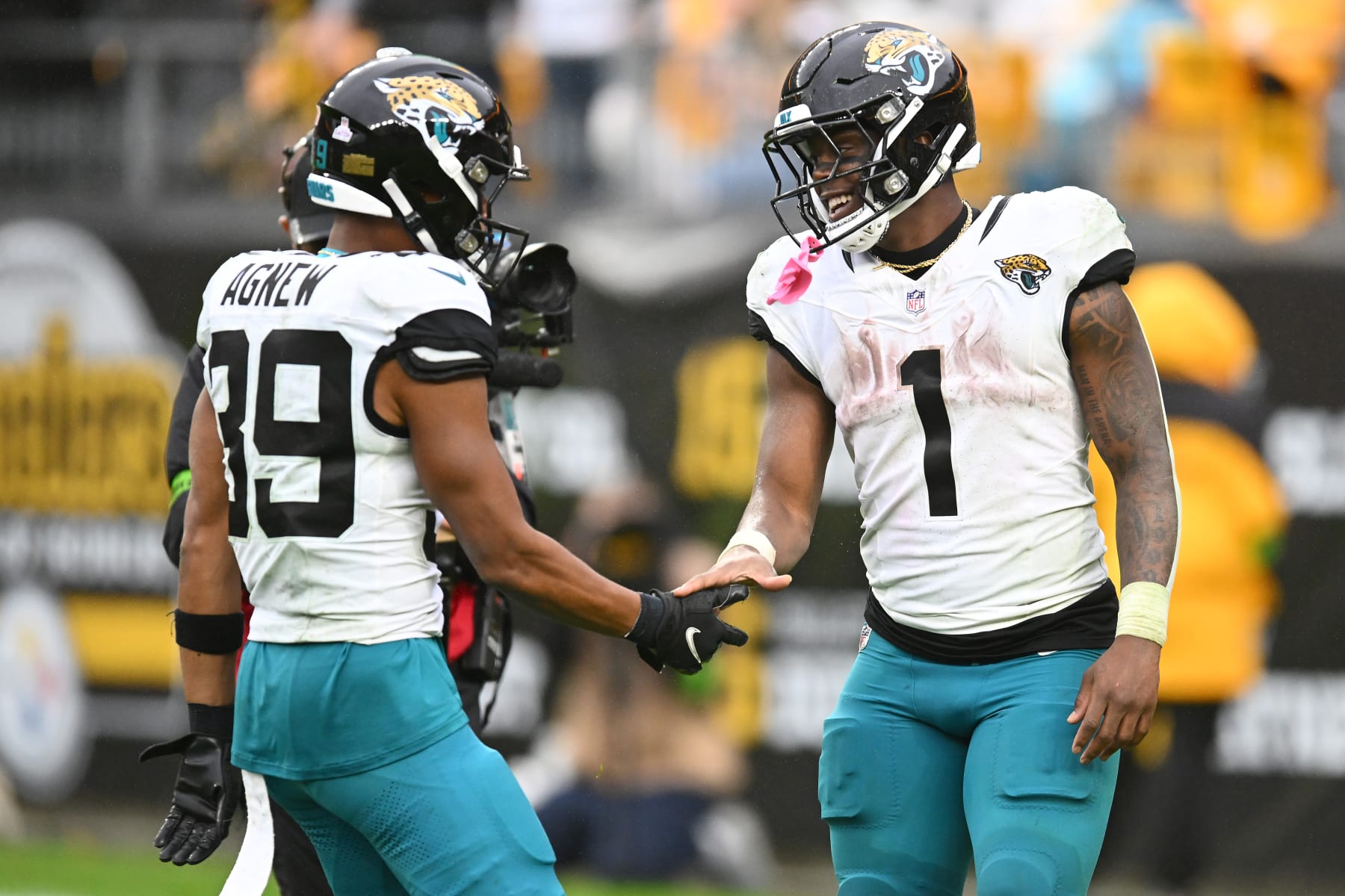 PITTSBURGH, PENNSYLVANIA - OCTOBER 29: Travis Etienne Jr. #1 of the Jacksonville Jaguars celebrates with Jamal Agnew #39 of the Jacksonville Jaguars after scoring a touchdown during the third quarter of the game against the Pittsburgh Steelers at Acrisure Stadium on October 29, 2023 in Pittsburgh, Pennsylvania. (Photo by Joe Sargent/Getty Images)