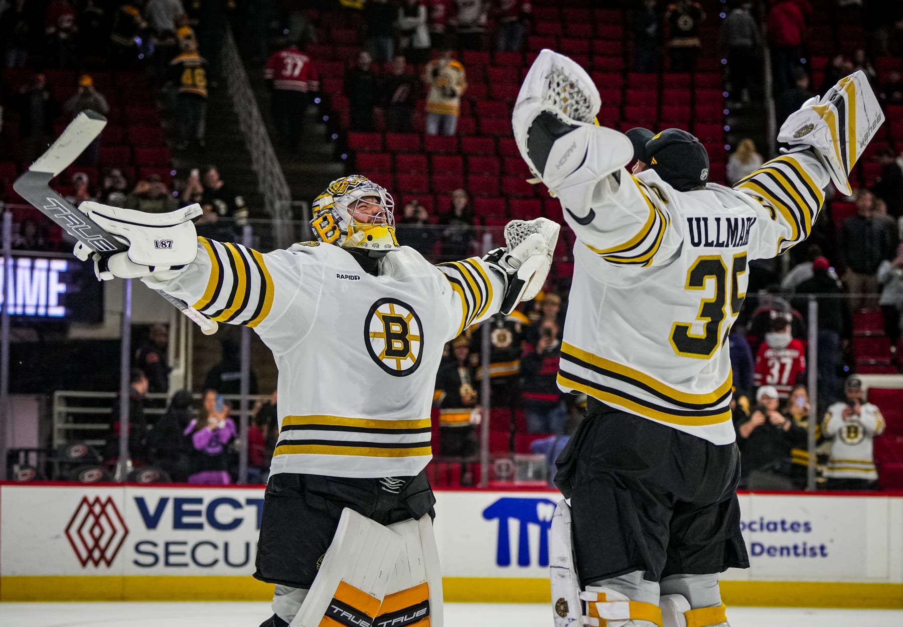 RALEIGH, NORTH CAROLINA - APRIL 04:  Jeremy Swayman #1 of the Boston Bruins celebrates with Linus Ullmark #35 after a 4-1 victory against the Carolina Hurricanes at PNC Arena on April 4, 2024 in Raleigh, North Carolina. (Photo by Josh Lavallee/NHLI via Getty Images)