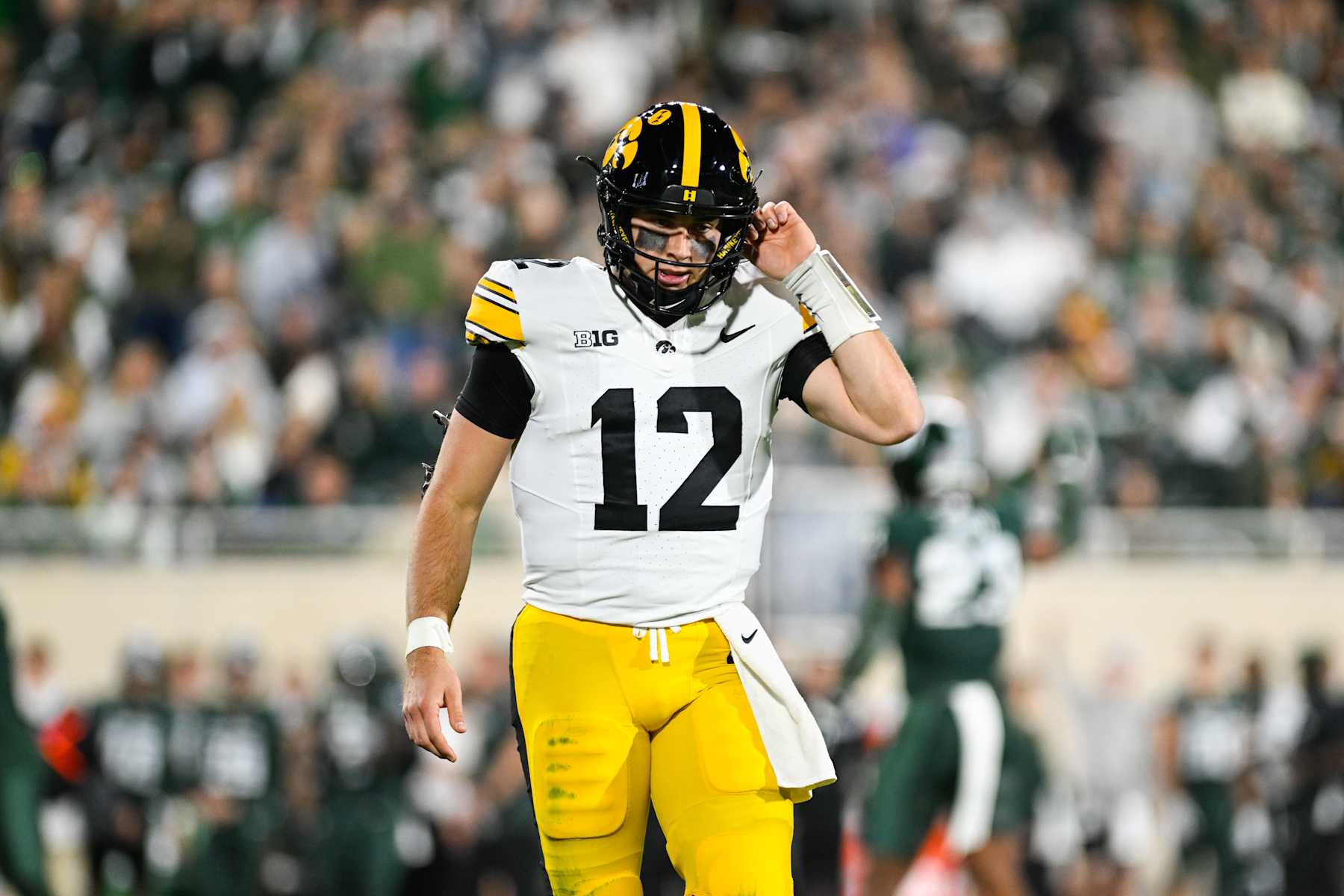 EAST LANSING, MI - OCTOBER 19: Iowa Hawkeyes quarterback Cade McNamara (12) walks off the field after a three-and-out during a college football game between the Michigan State Spartans and the Iowa Hawkeyes on October 19, 2024, at Spartan Stadium in East Lansing, MI. (Photo by Adam Ruff/Icon Sportswire via Getty Images)