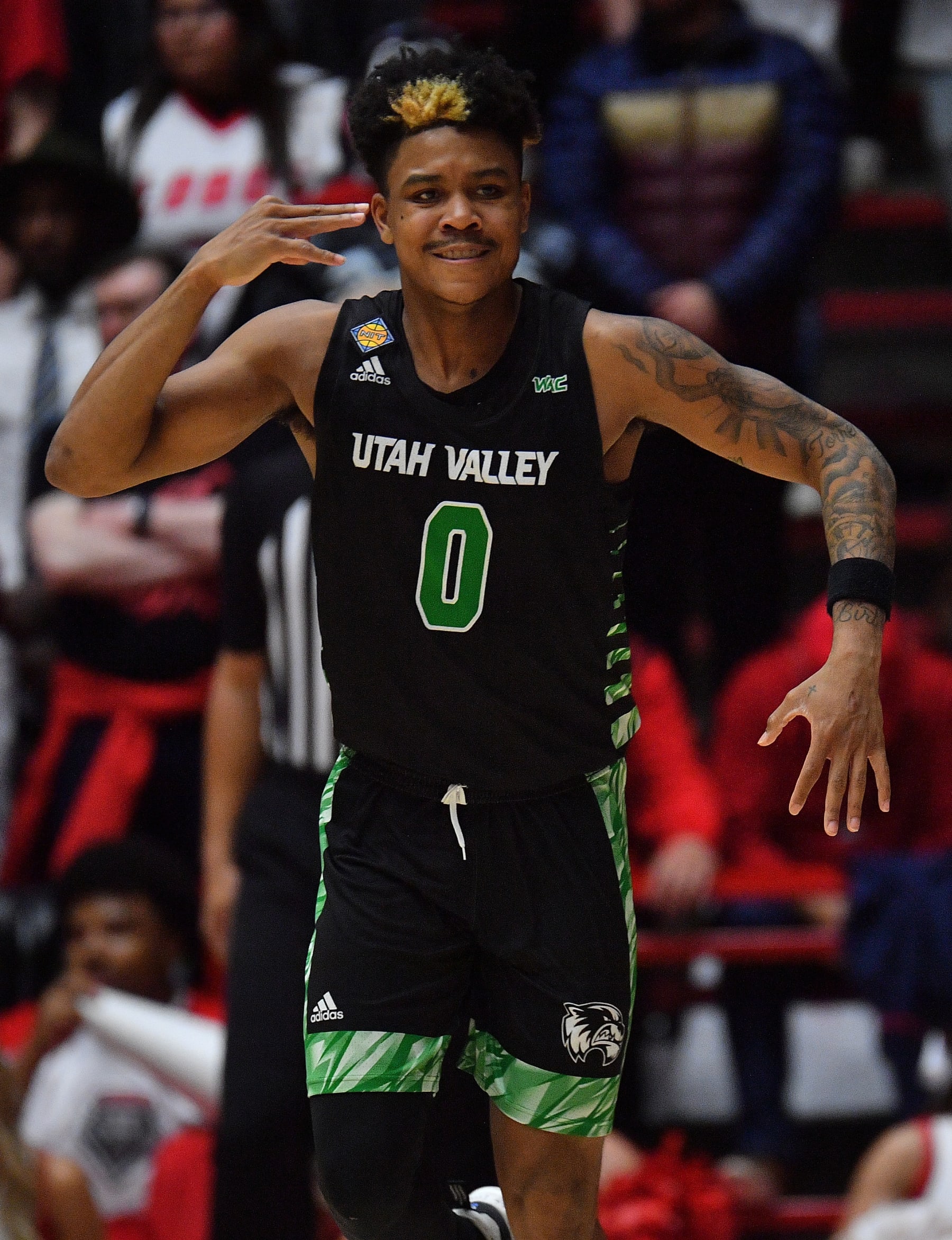 ALBUQUERQUE, NEW MEXICO - MARCH 15: Justin Harmon #0 of the Utah Valley Wolverines reacts after hitting a three-pointer against the New Mexico Lobos during the second half of the first round game in the 2023 National Invitation Tournament at The Pit on March 15, 2023 in Albuquerque, New Mexico. The Wolverines defeated the Lobos 83-69. (Photo by Sam Wasson/Getty Images)
