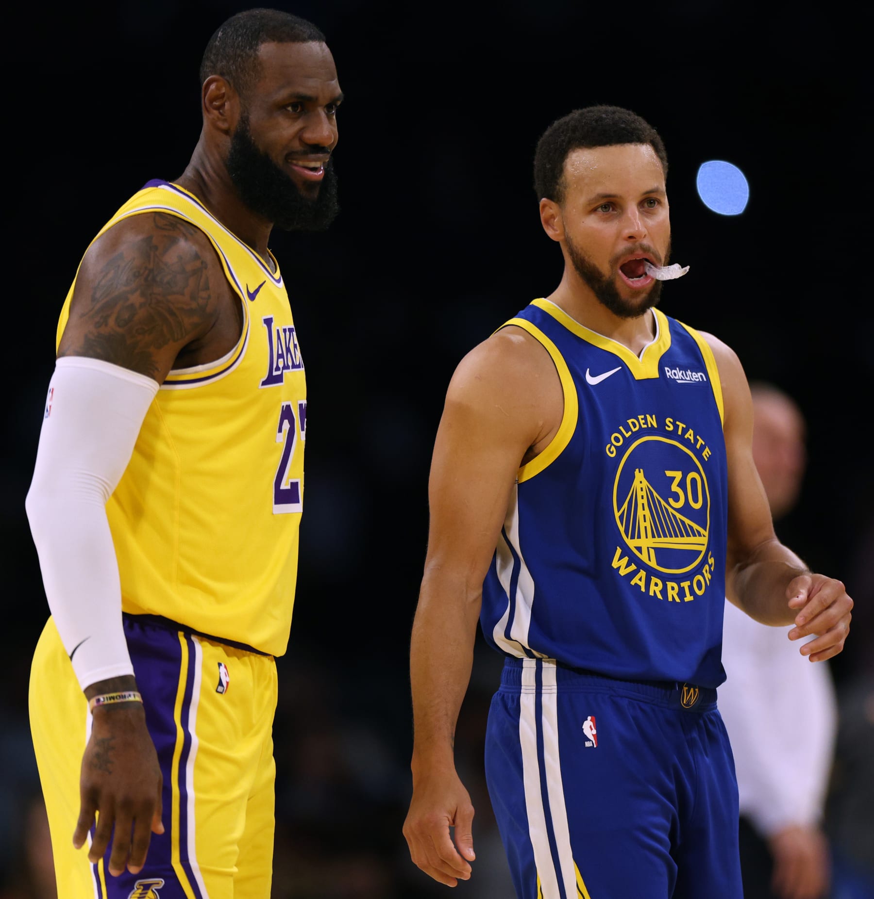 LOS ANGELES, CALIFORNIA - OCTOBER 13: LeBron James #23 of the Los Angeles Lakers and Stephen Curry #30 of the Golden State Warriors smile at center court before the start of a preseason game at Crypto.com Arena on October 13, 2023 in Los Angeles, California. (Photo by Harry How/Getty Images) NOTE TO USER: User expressly acknowledges and agrees that, by downloading and/or using this photograph, user is consenting to the terms and conditions of the Getty Images License Agreement. (Photo by Harry How/Getty Images)