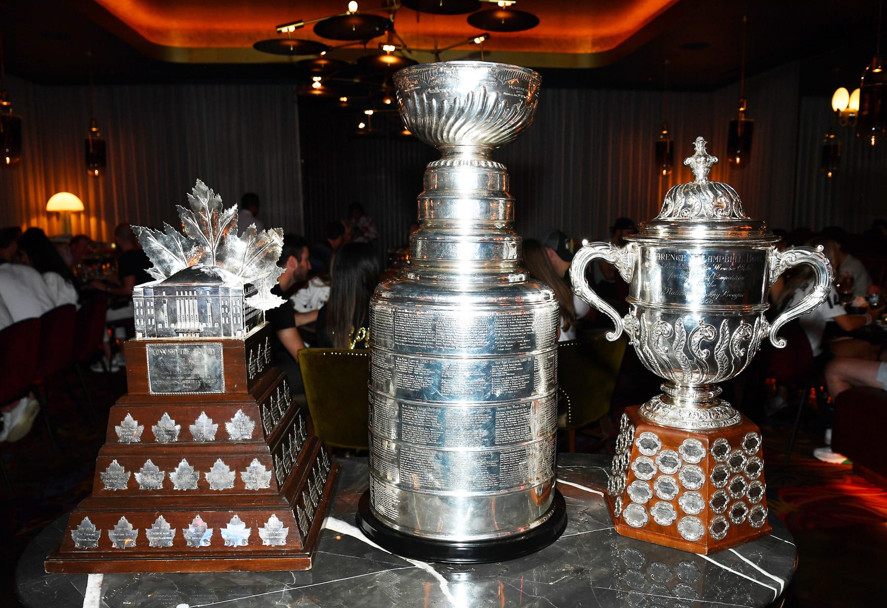 LAS VEGAS, NEVADA - JUNE 17: (L-R) The Conn Smythe Trophy, The Stanley Cup and the Clarence S. Campbell Bowl at Barry’s Downtown Prime at Circa Resort & Casino.Resort on June 17, 2023 in Las Vegas, Nevada. (Photo by Denise Truscello/Getty Images for Circa Resort & Casino)