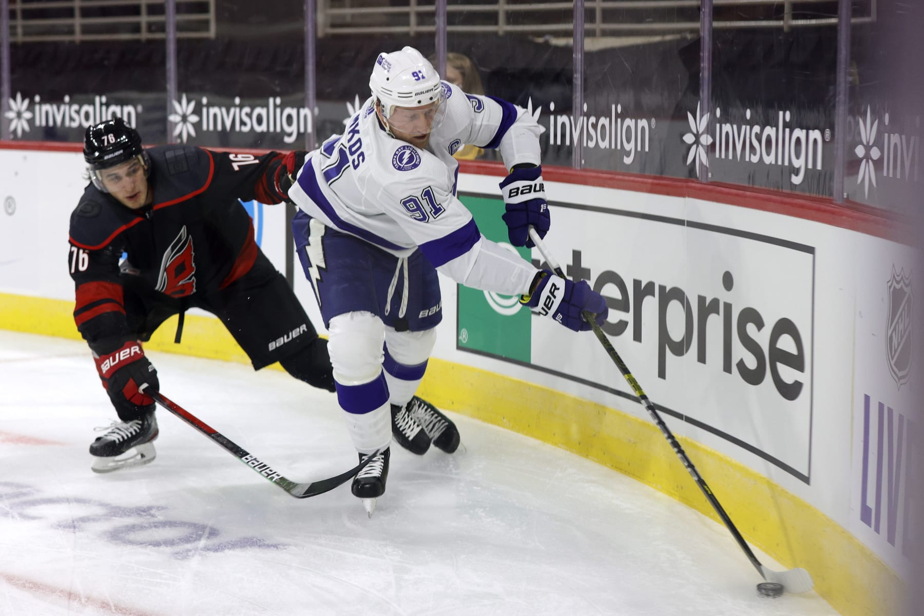 RALEIGH, NORTH CAROLINA - JANUARY 28: Steven Stamkos #91 of the Tampa Bay Lightning works to keep possession of the puck from Brady Skjei #76 of the Carolina Hurricanes during the second period of their game at PNC Arena on January 28, 2021 in Raleigh, North Carolina. (Photo by Jared C. Tilton/Getty Images)