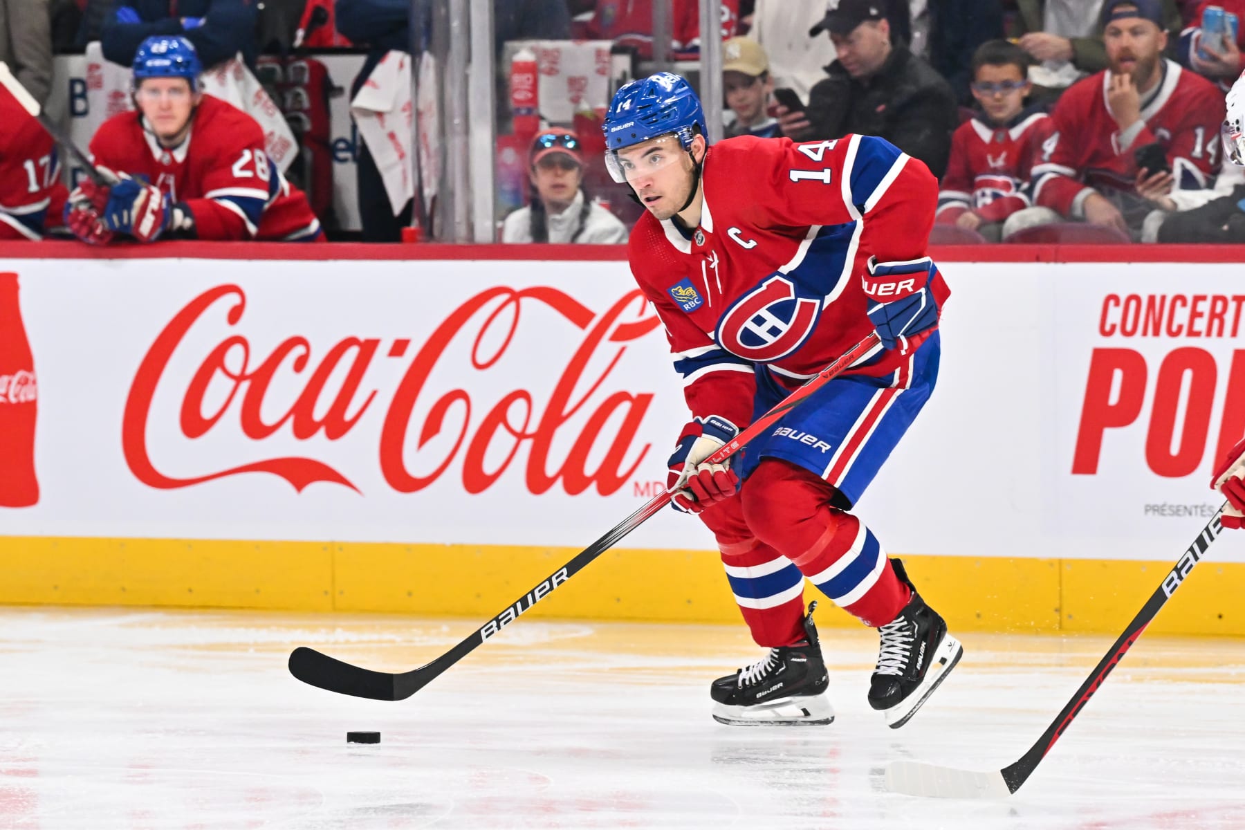 MONTREAL, CANADA - APRIL 16:  Nick Suzuki #14 of the Montreal Canadiens skates the puck during the second period against the Detroit Red Wings at the Bell Centre on April 16, 2024 in Montreal, Quebec, Canada.  The Detroit Red Wings defeated the Montreal Canadiens 5-4 in a shootout.  (Photo by Minas Panagiotakis/Getty Images)