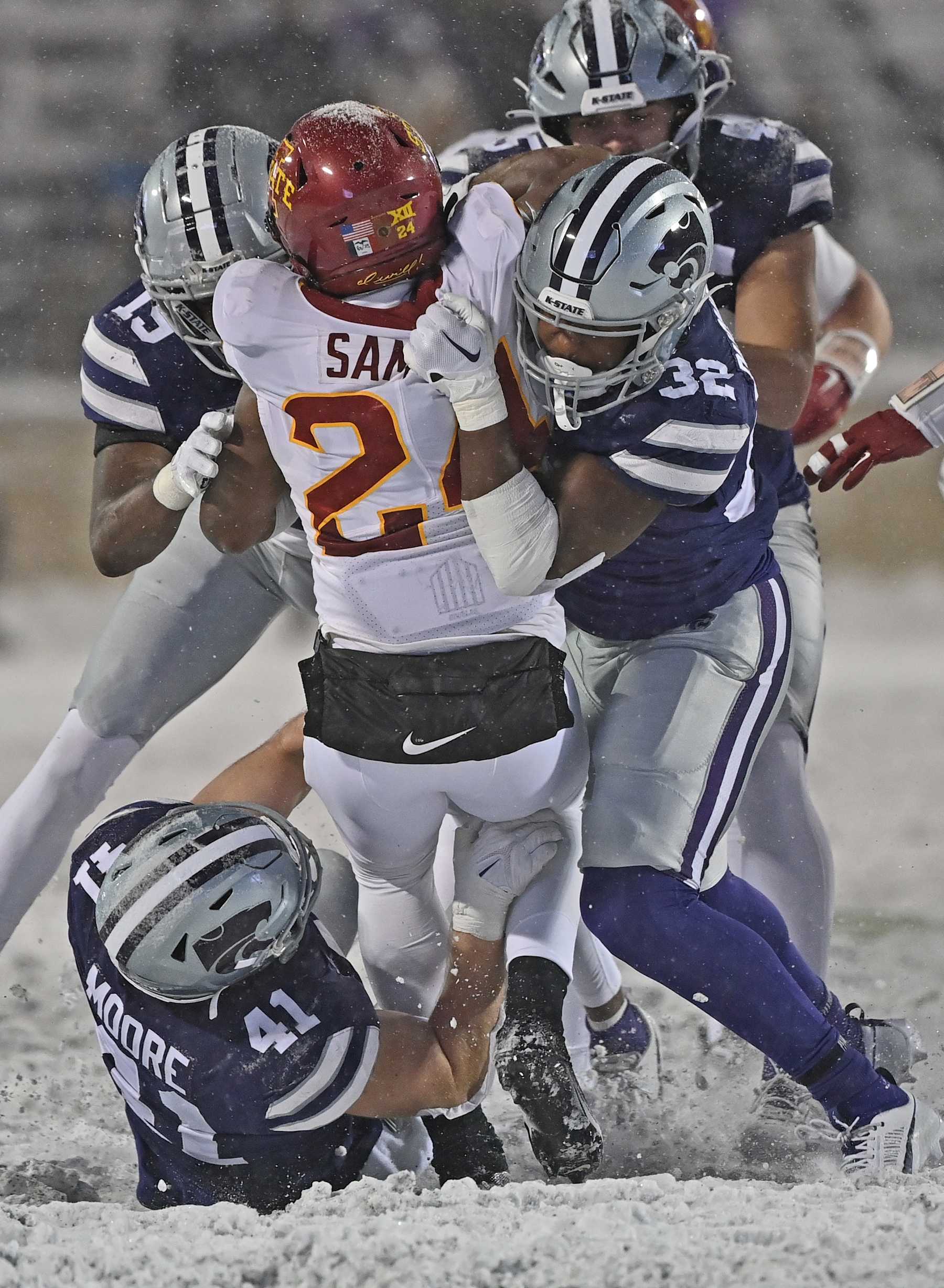 MANHATTAN, KS - NOVEMBER 25:  Linebacker Desmond Purnell #32 of the Kansas State Wildcats and linebacker Austin Moore #41 tackle running back Abu Sama III #24 of the Iowa State Cyclones for a loss in the second half at Bill Snyder Family Football Stadium on November 25, 2023 in Manhattan, Kansas. (Photo by Peter Aiken/Getty Images)