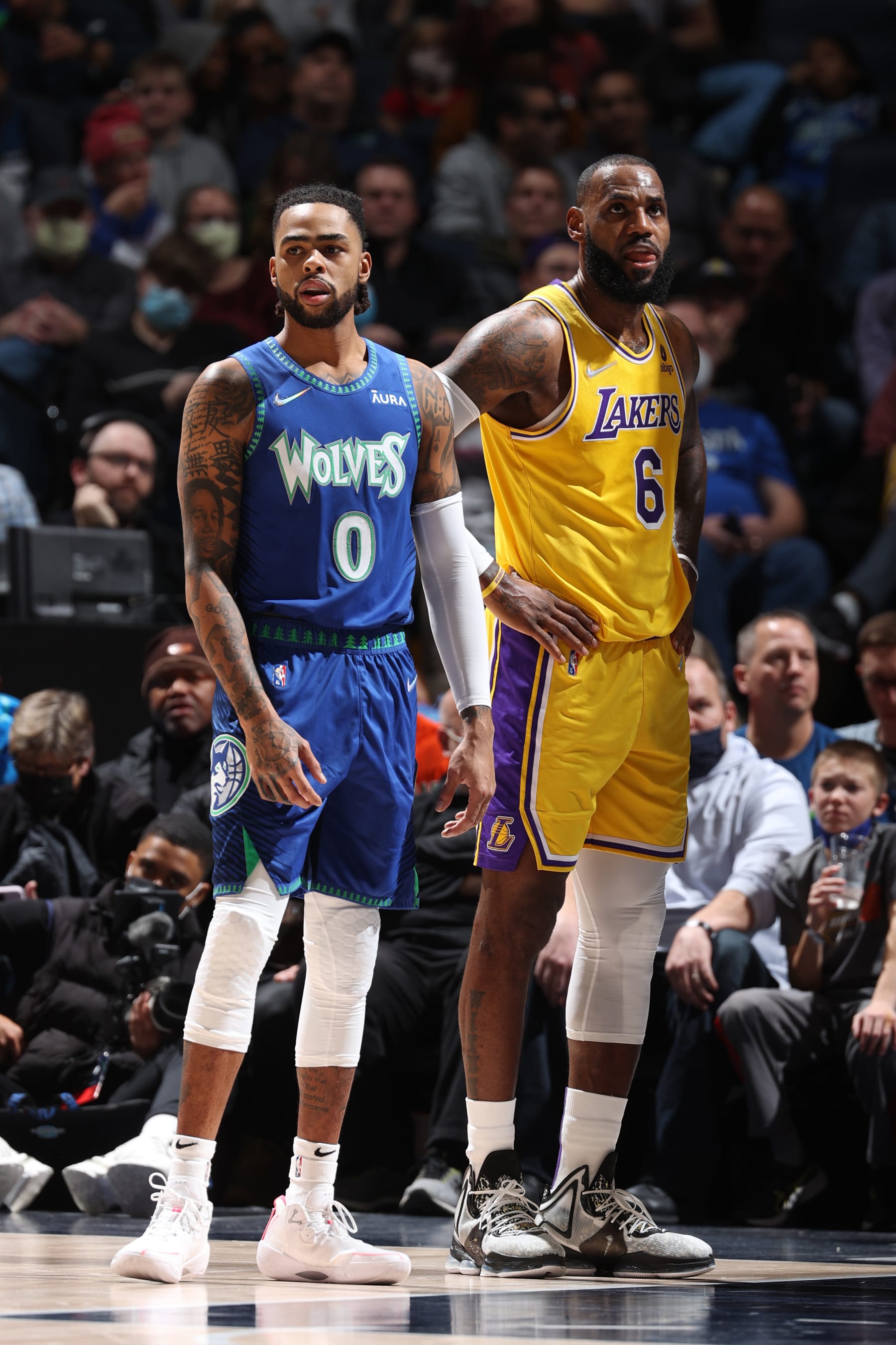 MINNEAPOLIS, MN -  DECEMBER 17: D'Angelo Russell #0 of the Minnesota Timberwolves and LeBron James #6 of the Los Angeles Lakers look on during the game on December 17, 2021 at Target Center in Minneapolis, Minnesota. NOTE TO USER: User expressly acknowledges and agrees that, by downloading and or using this Photograph, user is consenting to the terms and conditions of the Getty Images License Agreement. Mandatory Copyright Notice: Copyright 2021 NBAE (Photo by David Sherman/NBAE via Getty Images)