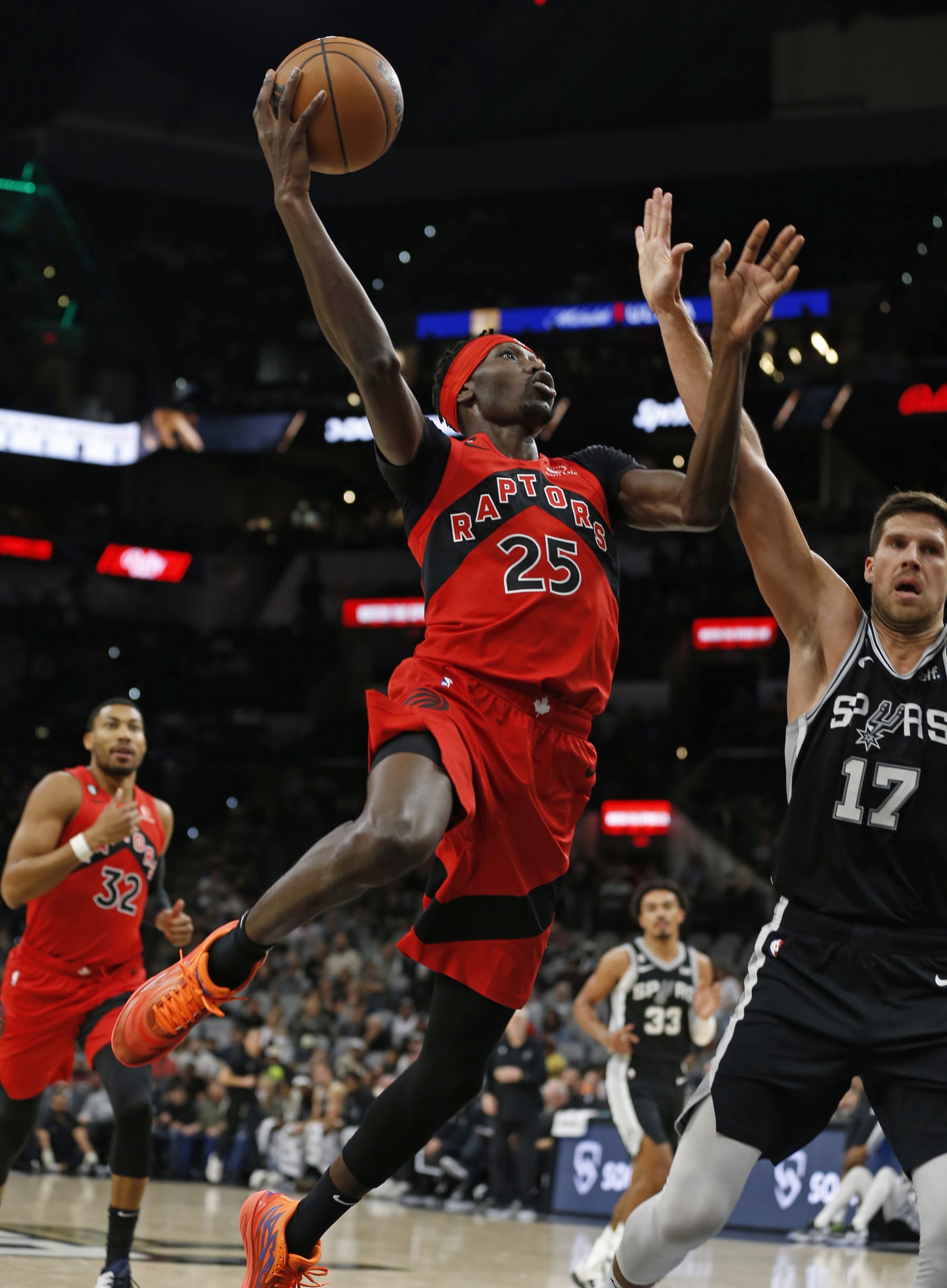 SAN ANTONIO, TX - NOVEMBER 02: Chris Boucher #25 of the Toronto Raptors drives past Doug McDermott #17 of the San Antonio Spurs in the first half at AT&T Center on November 02, 2022 in San Antonio, Texas. NOTE TO USER: User expressly acknowledges and agrees that, by downloading and or using this photograph, User is consenting to terms and conditions of the Getty Images License Agreement. (Photo by Ronald Cortes/Getty Images)