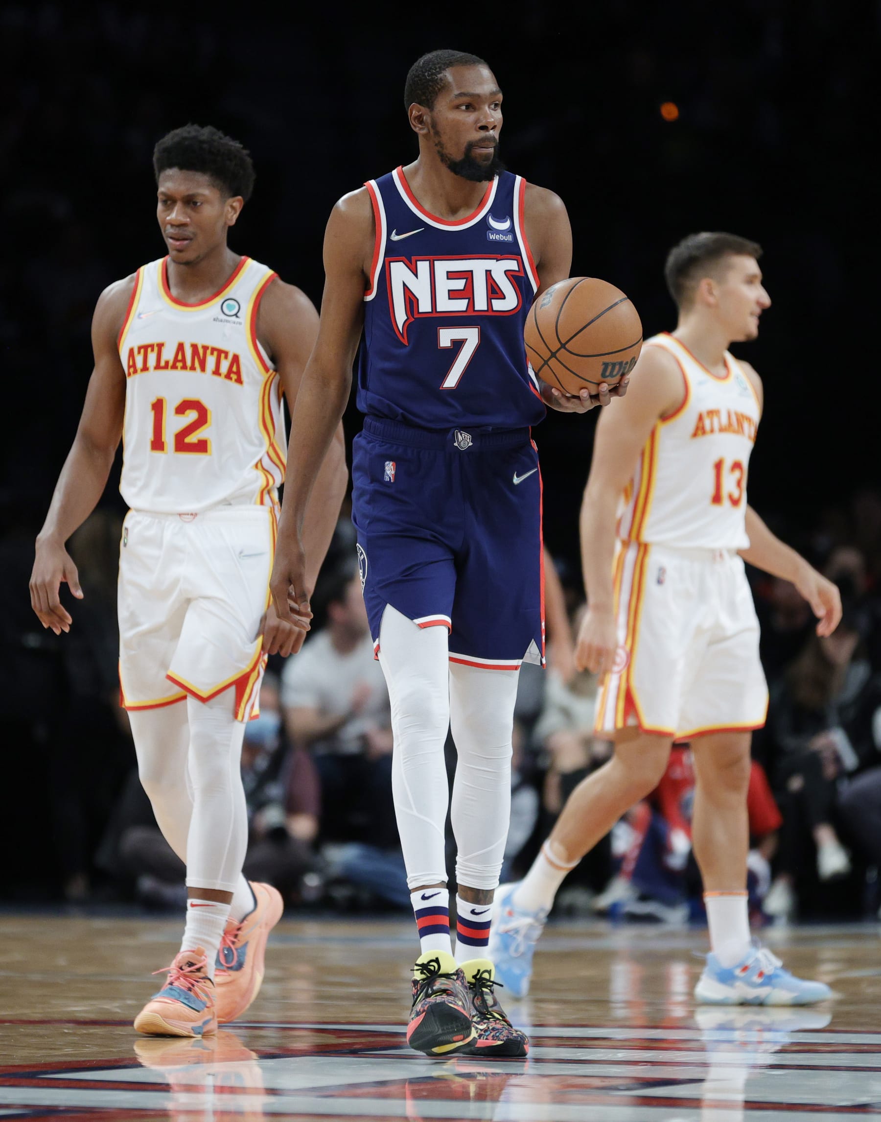 NEW YORK, NEW YORK - NOVEMBER 03: Kevin Durant #7 of the Brooklyn Nets and De'Andre Hunter #12 of the Atlanta Hawks look on during the first half against the Brooklyn Nets on November 03, 2021 in the Brooklyn borough of New York City. NOTE TO USER: User expressly acknowledges and agrees that, by downloading and or using this photograph, user is consenting to the terms and conditions of the Getty Images License Agreement. (Photo by Sarah Stier/Getty Images)