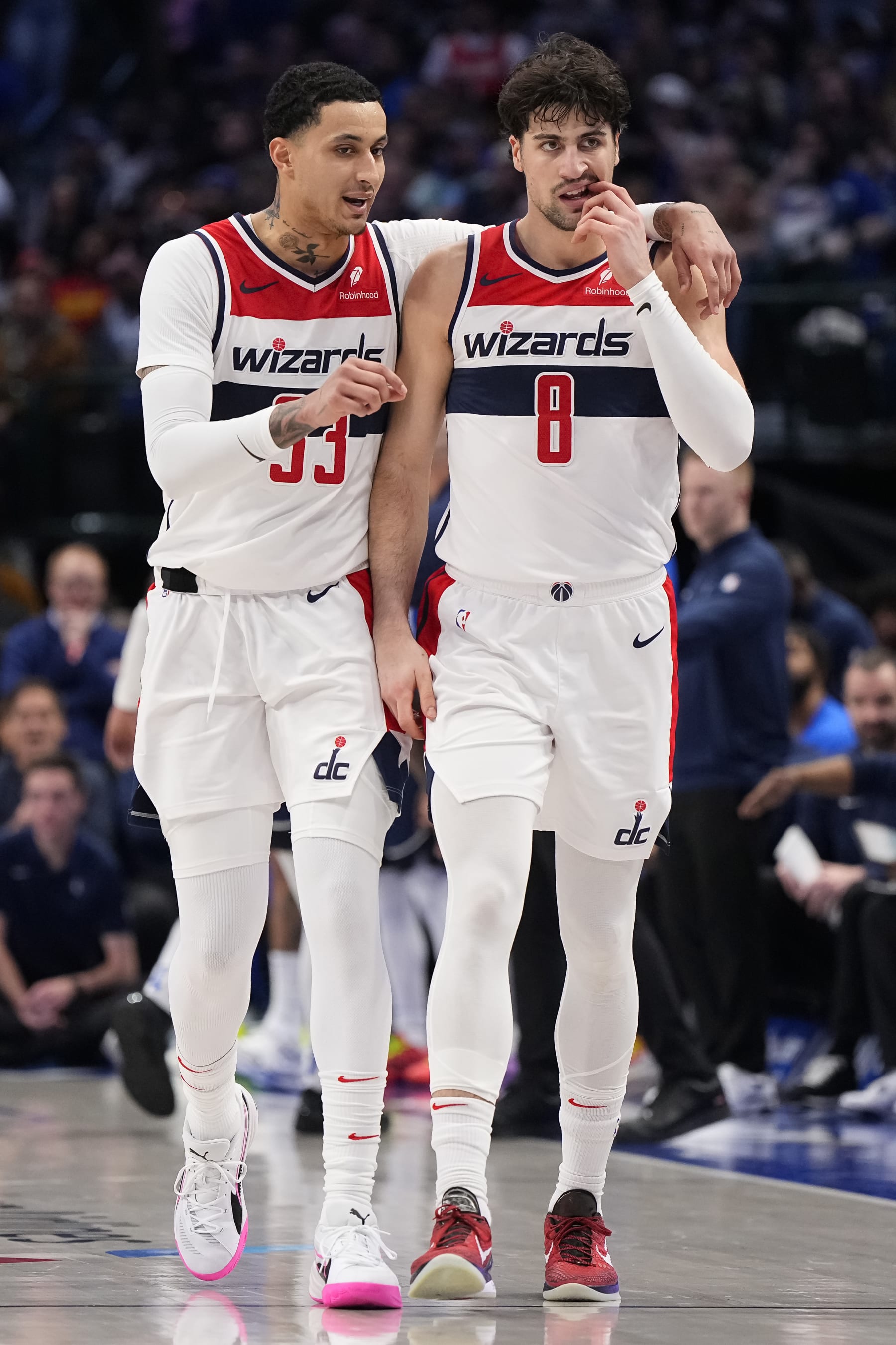 DALLAS, TEXAS - FEBRUARY 12: Kyle Kuzma #33 and Deni Avdija #8 of the Washington Wizards talk while walking up the court during the second half against the Dallas Mavericks at American Airlines Center on February 12, 2024 in Dallas, Texas. NOTE TO USER: User expressly acknowledges and agrees that, by downloading and or using this photograph, User is consenting to the terms and conditions of the Getty Images License Agreement. (Photo by Sam Hodde/Getty Images)