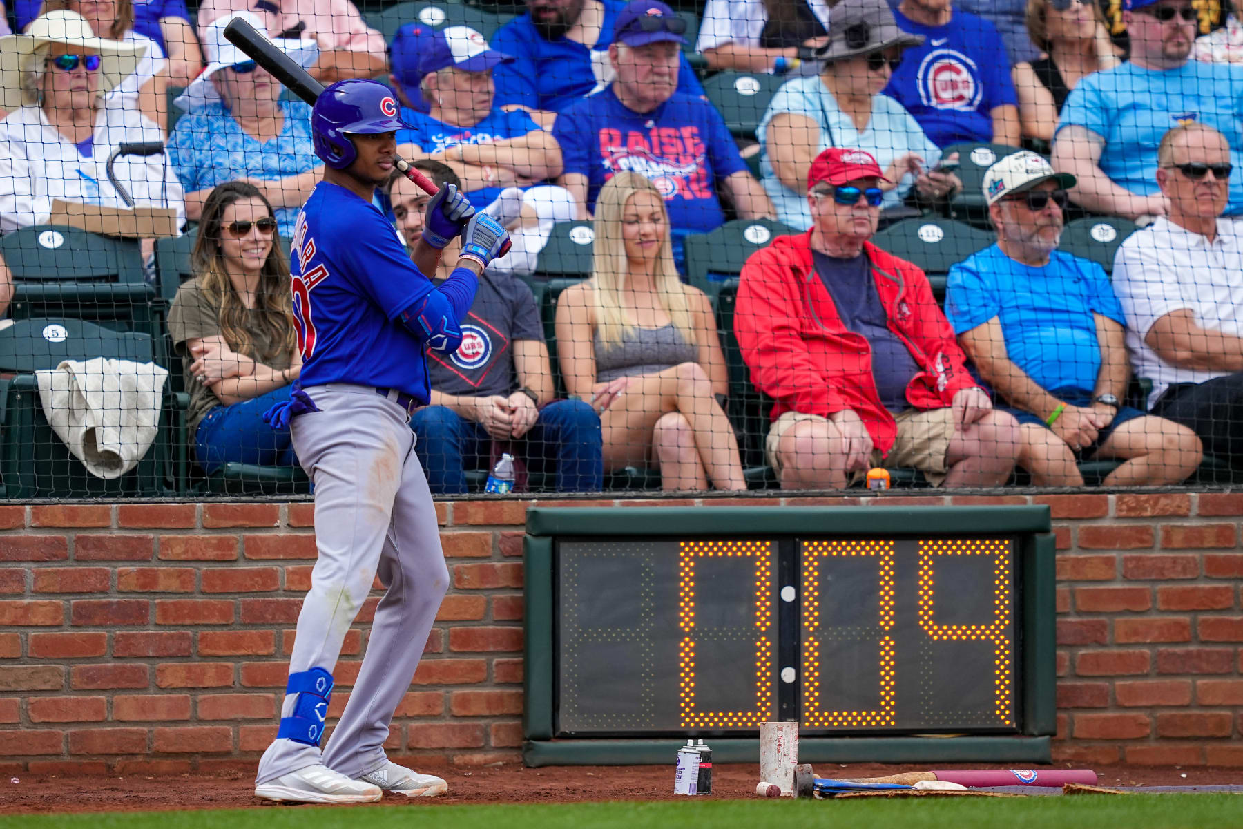 SURPRISE, ARIZONA - MARCH 07: Sergio Alcantara #60 of the Chicago Cubs waits in the on deck circle next to the pitch clock in the fourth inning against the Texas Rangers during a Spring Training game at Surprise Stadium on March 07, 2023 in Surprise, Arizona. (Photo by Dylan Buell/Getty Images)