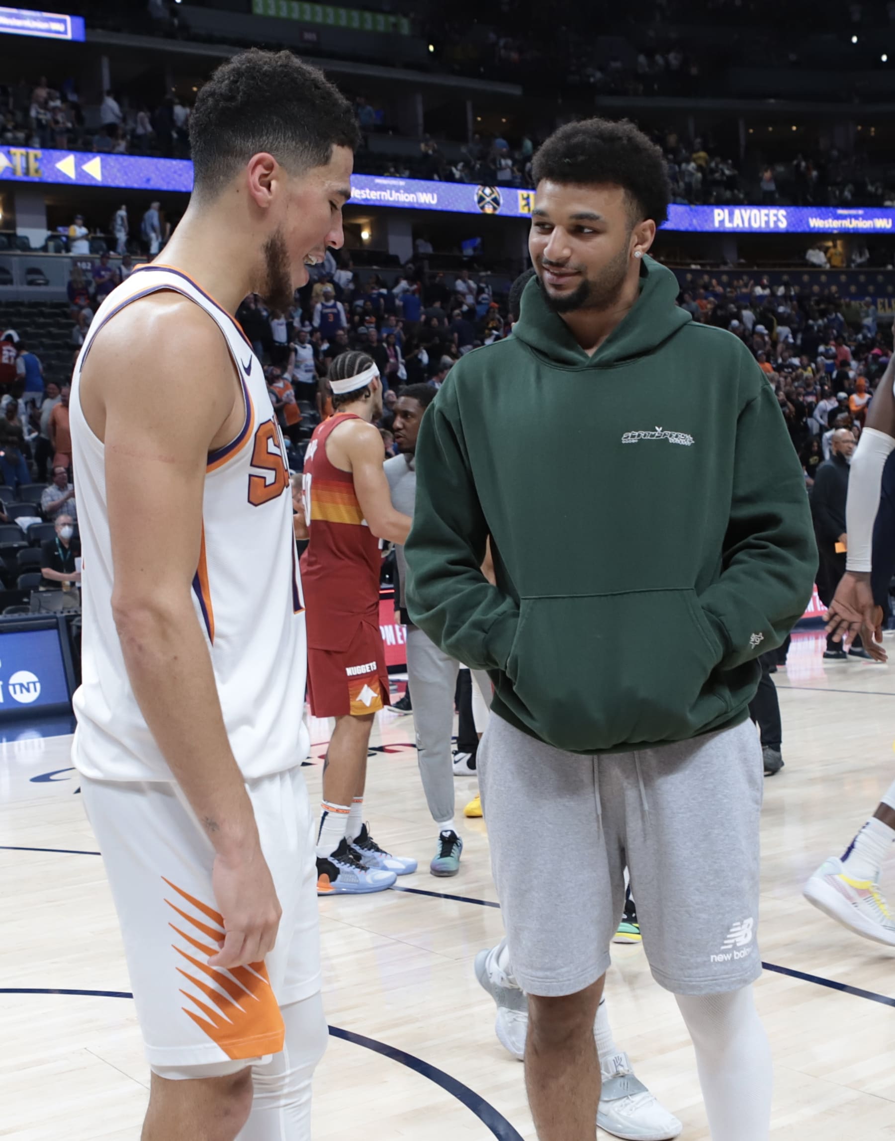 DENVER, CO - JUNE 13:  Devin Booker #1 of the Phoenix Suns talks with Jamal Murray #27 of the Denver Nuggets during Round 2, Game 4 of the 2021 NBA Playoffs on June 13, 2021 at the Ball Arena in Denver, Colorado. NOTE TO USER: User expressly acknowledges and agrees that, by downloading and/or using this Photograph, user is consenting to the terms and conditions of the Getty Images License Agreement. Mandatory Copyright Notice: Copyright 2021 NBAE (Photo by Jim Poorten/NBAE via Getty Images)