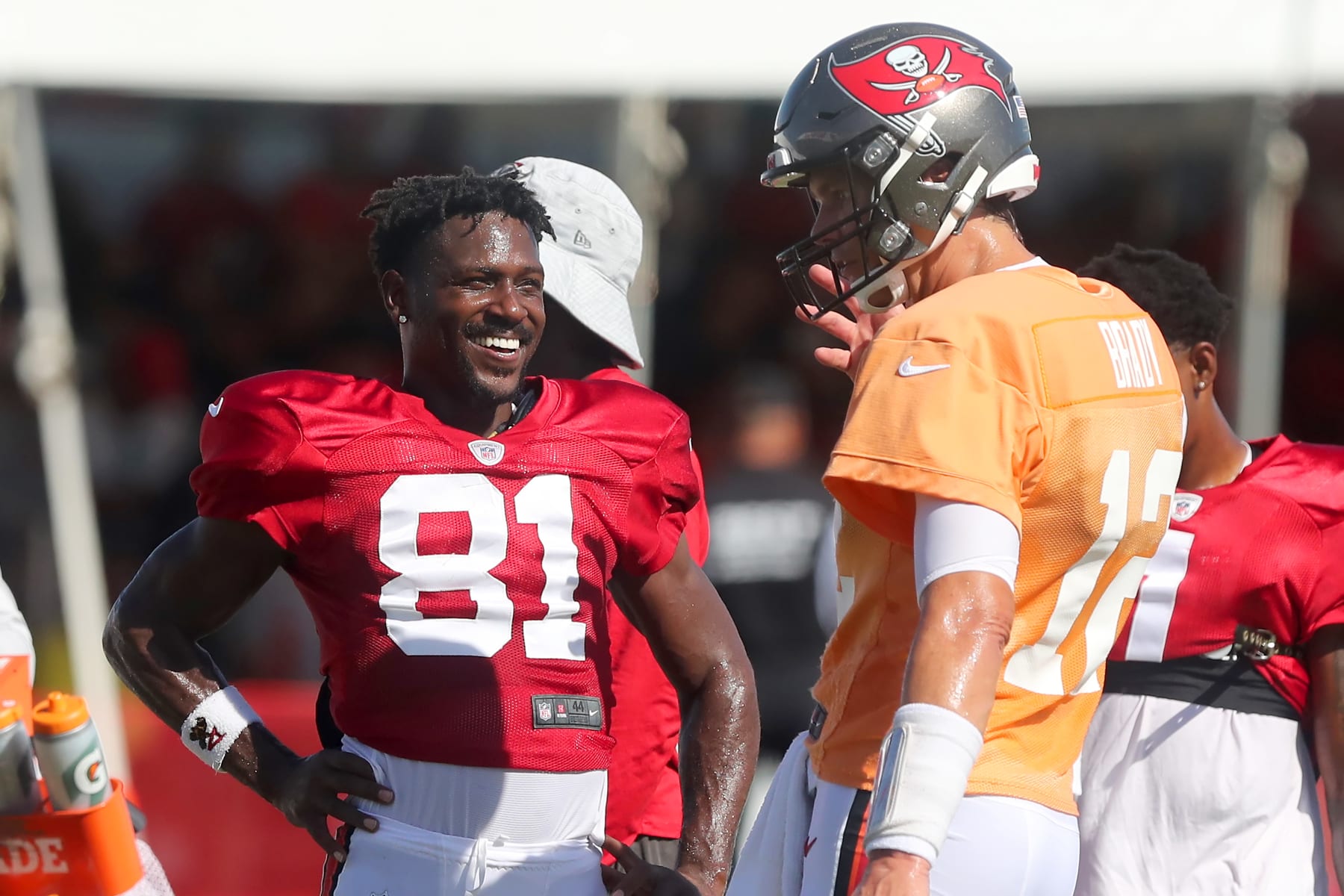 TAMPA, FL - AUG 18: Antonio Brown (81) of the Buccaneers smiles as he talks with Tom Brady (12) during the Tennessee Titans &  Tampa Bay Buccaneers joint training camp on August 18, 2021 at the AdventHealth Training Center at One Buccaneer Place in Tampa, Florida. (Photo by Cliff Welch/Icon Sportswire via Getty Images)