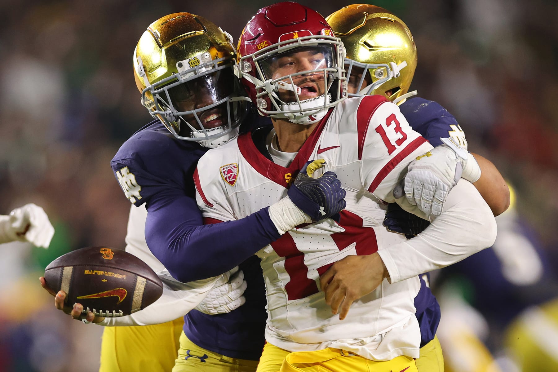 SOUTH BEND, INDIANA - OCTOBER 14: Caleb Williams #13 of the USC Trojans is sacked by Jaylen Sneed #3 of the Notre Dame Fighting Irish during the second half at Notre Dame Stadium on October 14, 2023 in South Bend, Indiana. (Photo by Michael Reaves/Getty Images)