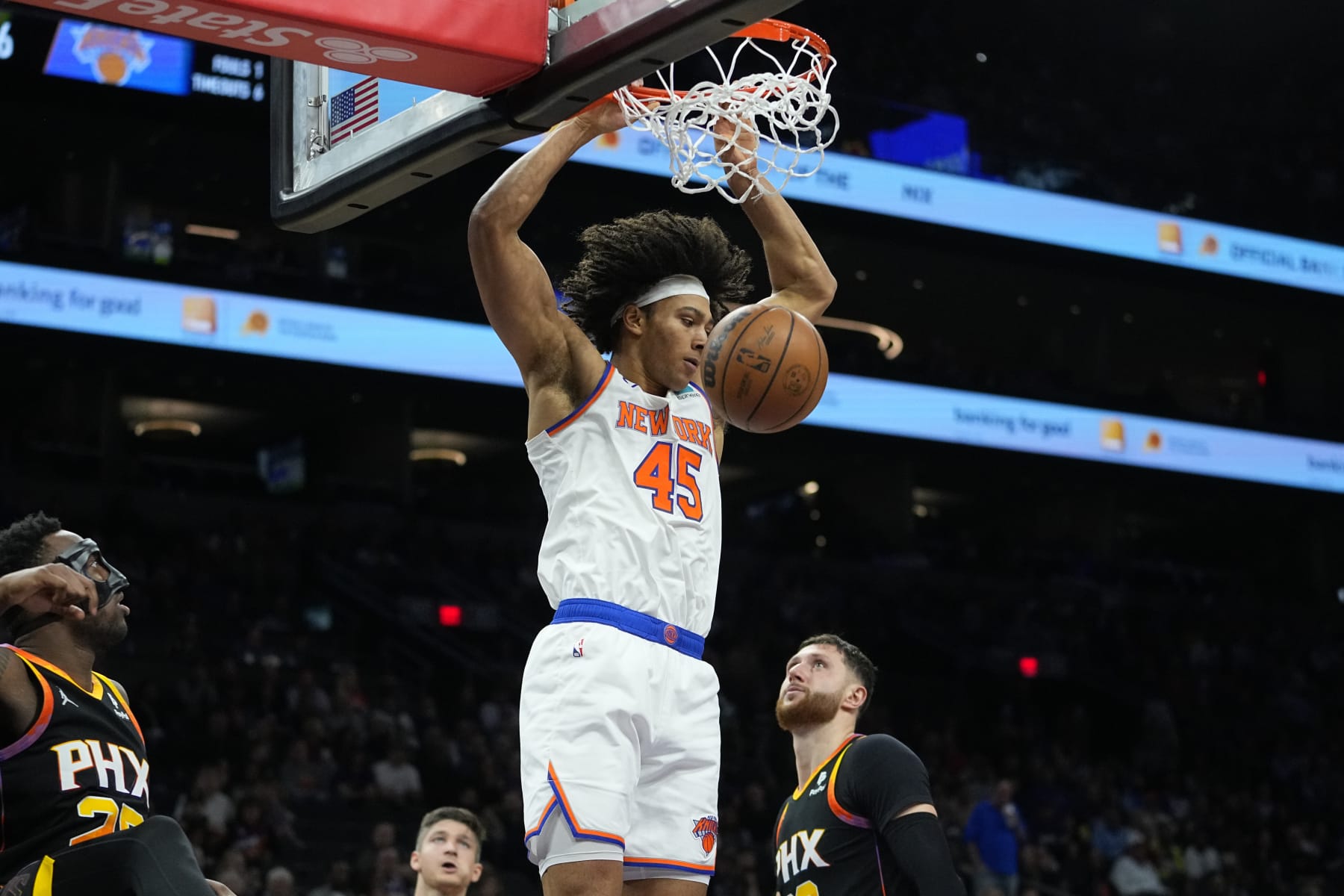 New York Knicks center Jericho Sims (45) dunks against the Phoenix Suns during the second half of an NBA basketball game, Friday, Dec. 15, 2023, in Phoenix. (AP Photo/Matt York)