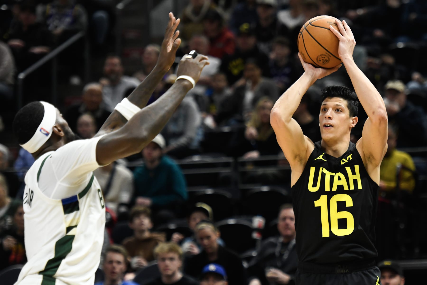 SALT LAKE CITY, UTAH - FEBRUARY 04: Simone Fontecchio #16 of the Utah Jazz shoots over Bobby Portis #9 of the Milwaukee Bucks during the second half at Delta Center on February 04, 2024 in Salt Lake City, Utah. NOTE TO USER: User expressly acknowledges and agrees that, by downloading and or using this photograph, User is consenting to the terms and conditions of the Getty Images License Agreement. (Photo by Alex Goodlett/Getty Images)