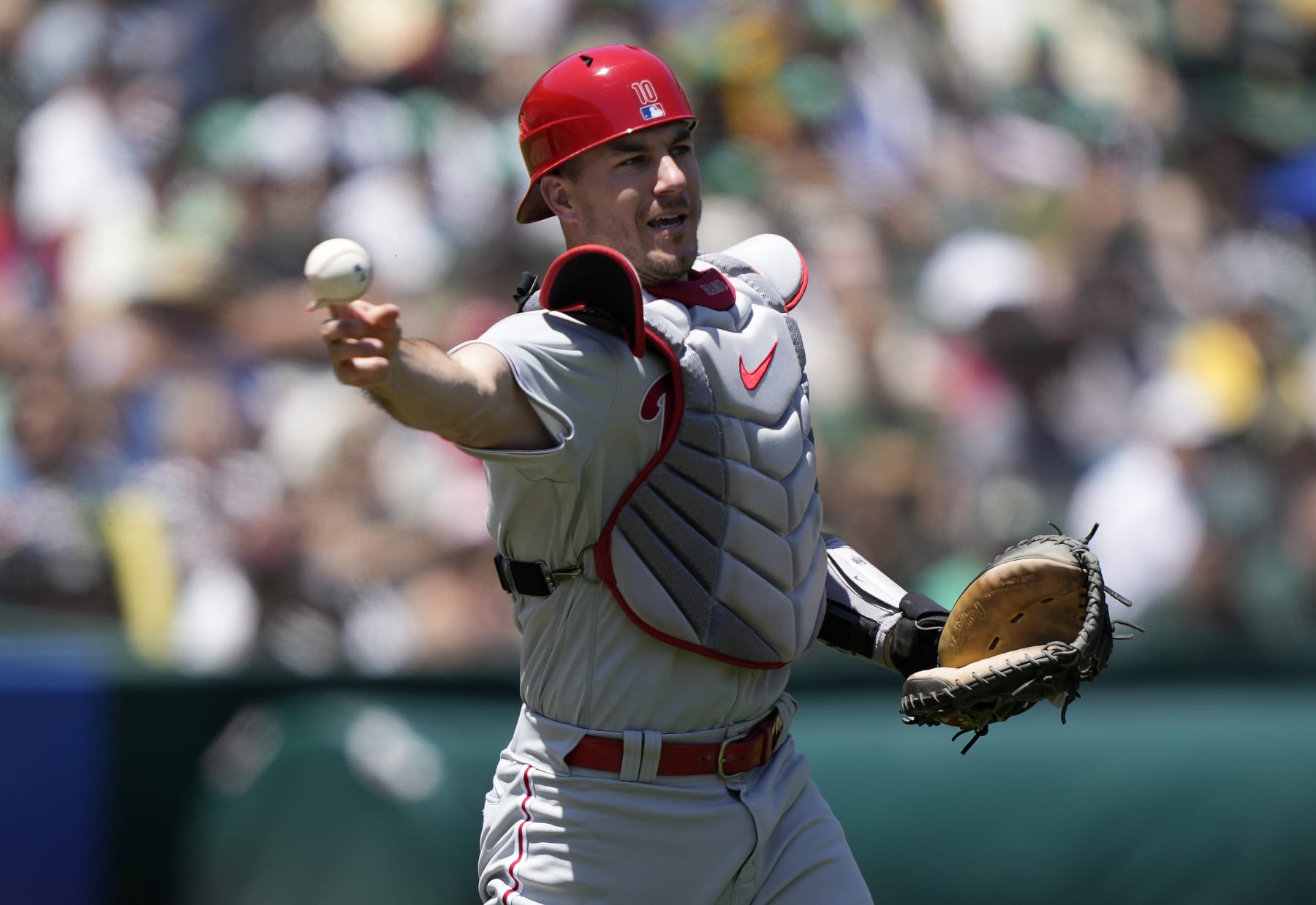 OAKLAND, CALIFORNIA - JUNE 17: J.T. Realmuto #10 of the Philadelphia Phillies throws to first base throwing out Jonah Bride #26 of the Oakland Athletics in the bottom of the second inning of a major league baseball game at RingCentral Coliseum on June 17, 2023 in Oakland, California. (Photo by Thearon W. Henderson/Getty Images)
