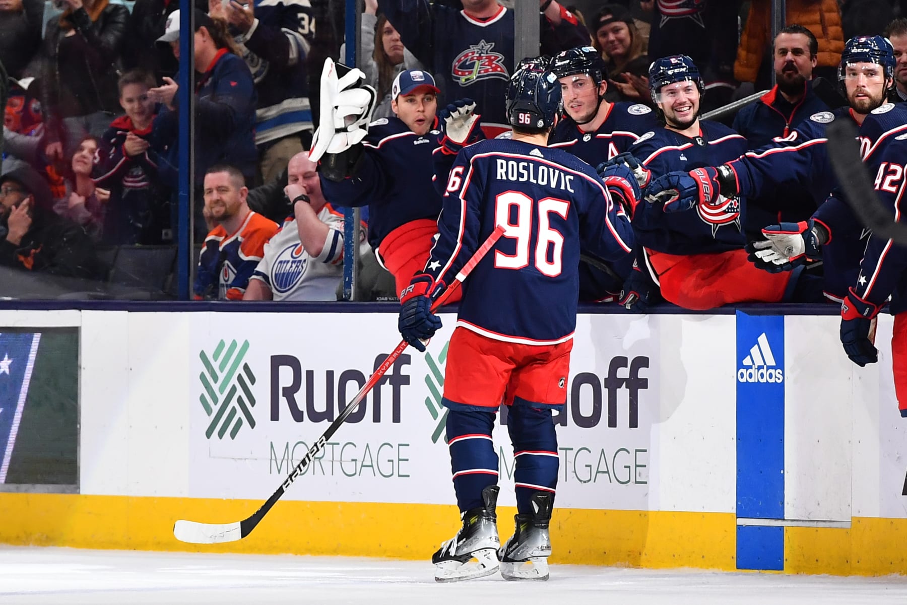 COLUMBUS, OHIO - MARCH 7: Jack Roslovic #96 of the Columbus Blue Jackets high-fives his teammates after scoring an empty-net goal during the third period of a game against the Edmonton Oilers at Nationwide Arena on March 7, 2024 in Columbus, Ohio. (Photo by Ben Jackson/NHLI via Getty Images)