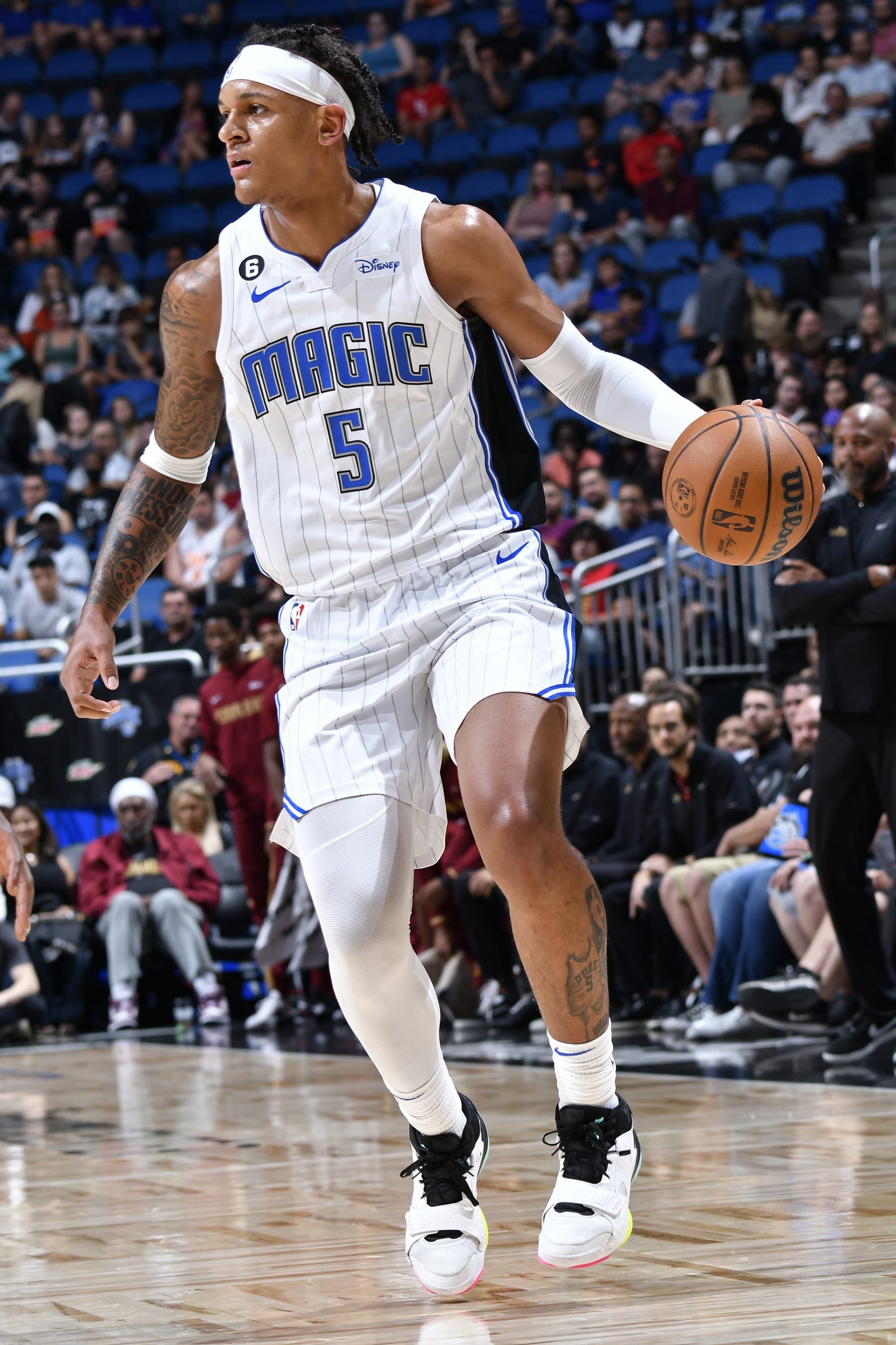 ORLANDO, FL - OCTOBER 14: Paolo Banchero #5 of the Orlando Magic dribbles the ball against the Cleveland Cavaliers during a preseason game on October 14, 2022 at Amway Center in Orlando, Florida. NOTE TO USER: User expressly acknowledges and agrees that, by downloading and or using this photograph, User is consenting to the terms and conditions of the Getty Images License Agreement. Mandatory Copyright Notice: Copyright 2022 NBAE (Photo by Fernando Medina/NBAE via Getty Images)