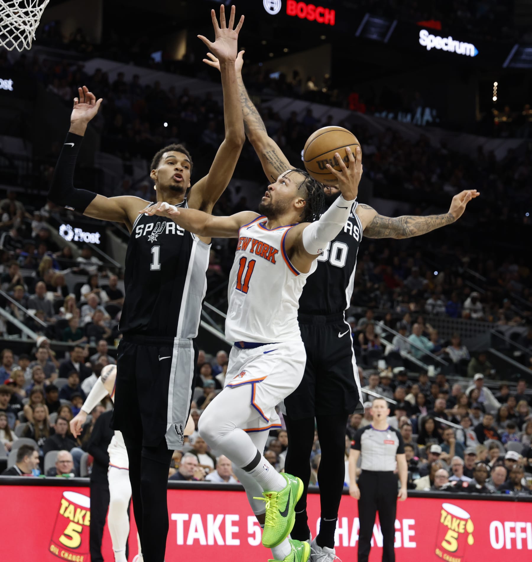 SAN ANTONIO, TX - MARCH 29: Jalen Brunson #11 of the New York Knicks drives on Victor Wembanyama #1 of the San Antonio Spurs during the second half at Frost Bank Center on March 29, 2024 in San Antonio, Texas. NOTE TO USER: User expressly acknowledges and agrees that, by downloading and or using this photograph, User is consenting to terms and conditions of the Getty Images License Agreement. (Photo by Ronald Cortes/Getty Images)