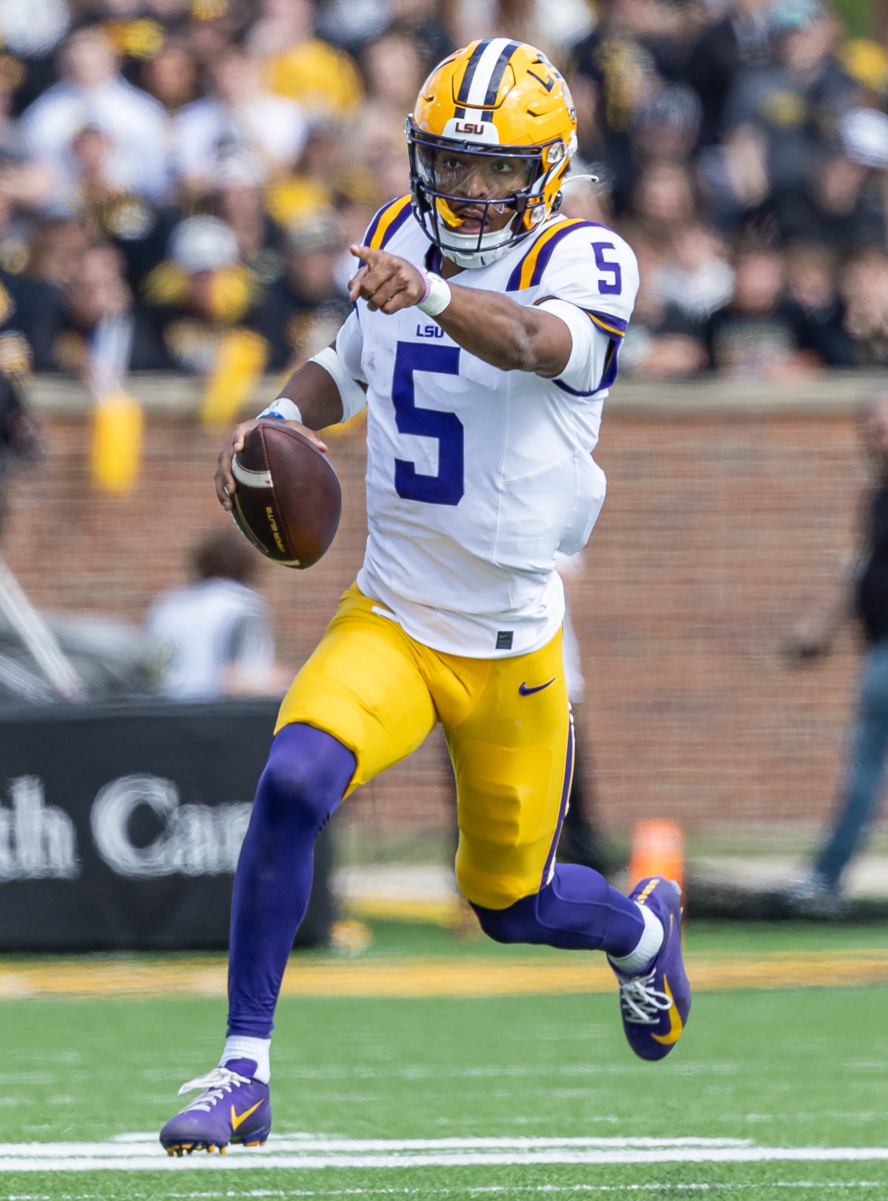 COLUMBIA, MISSOURI - OCTOBER 7: Jayden Daniels #5 of the LSU Tigers runs the ball during the game against the Missouri Tigers at Faurot Field/Memorial Stadium on October 7, 2023 in Columbia, Missouri. (Photo by Michael Hickey/Getty Images)