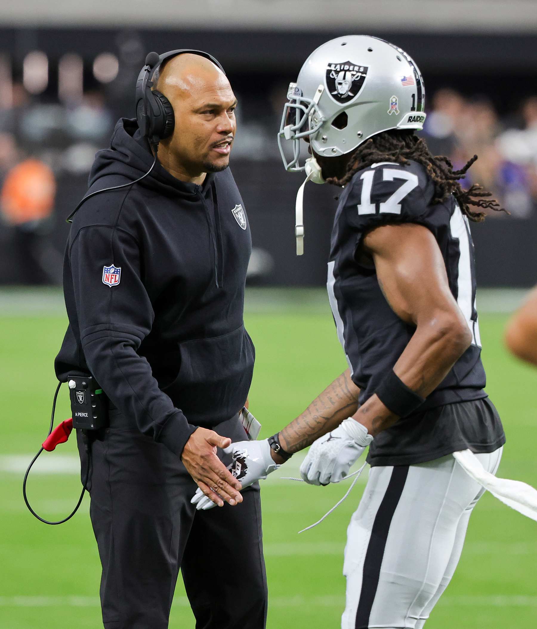 LAS VEGAS, NEVADA - NOVEMBER 05: Interim head coach Antonio Pierce of the Las Vegas Raiders greets wide receiver Davante Adams #17 as he runs off the field after a touchdown by his teammate Jakobi Meyers #16 in the first quarter of a game against the New York Giants at Allegiant Stadium on November 05, 2023 in Las Vegas, Nevada. The Raiders defeated the Giants 30-6. (Photo by Ethan Miller/Getty Images)