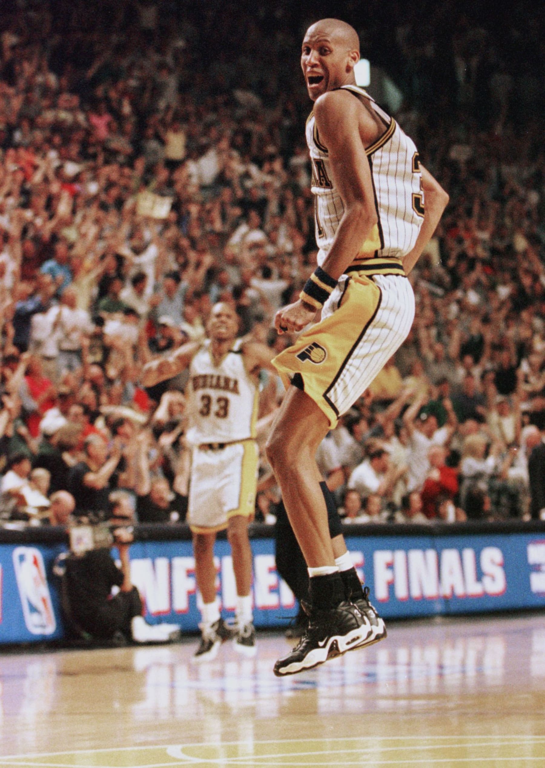 Reggie Miller of the Indiana Pacers jumps in the air after making the winning basket in the last few seconds 25 May during the second half of game four of their NBA Eastern Conference finals game at Market Square Arena in Indianapolis, IN. The Pacers won the game 96-94 to tie the series at two games apiece.  AFP PHOTO/John RUTHROFF (Photo by JOHN RUTHROFF / AFP)        (Photo credit should read JOHN RUTHROFF/AFP via Getty Images)