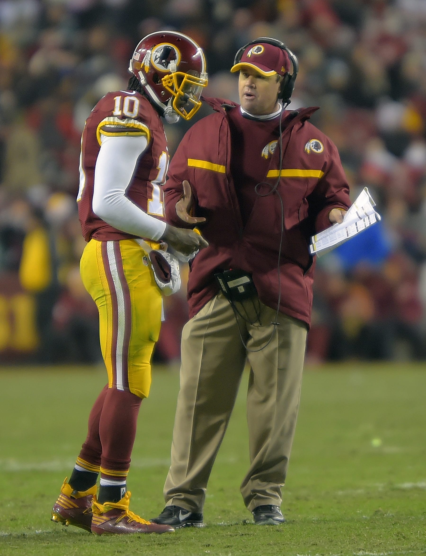 LANDOVER MD, DECEMBER 20: Washington quarterback Robert Griffin III (10), left, talks with  head coach Jay Gruden during a 4th quarter time out as the Washington Redskins defeated the Philadelphia Eagles 27-24 at  FedEx Field in Landover MD, December 20, 2014 (Photo by John McDonnell/The Washington Post via Getty Images)