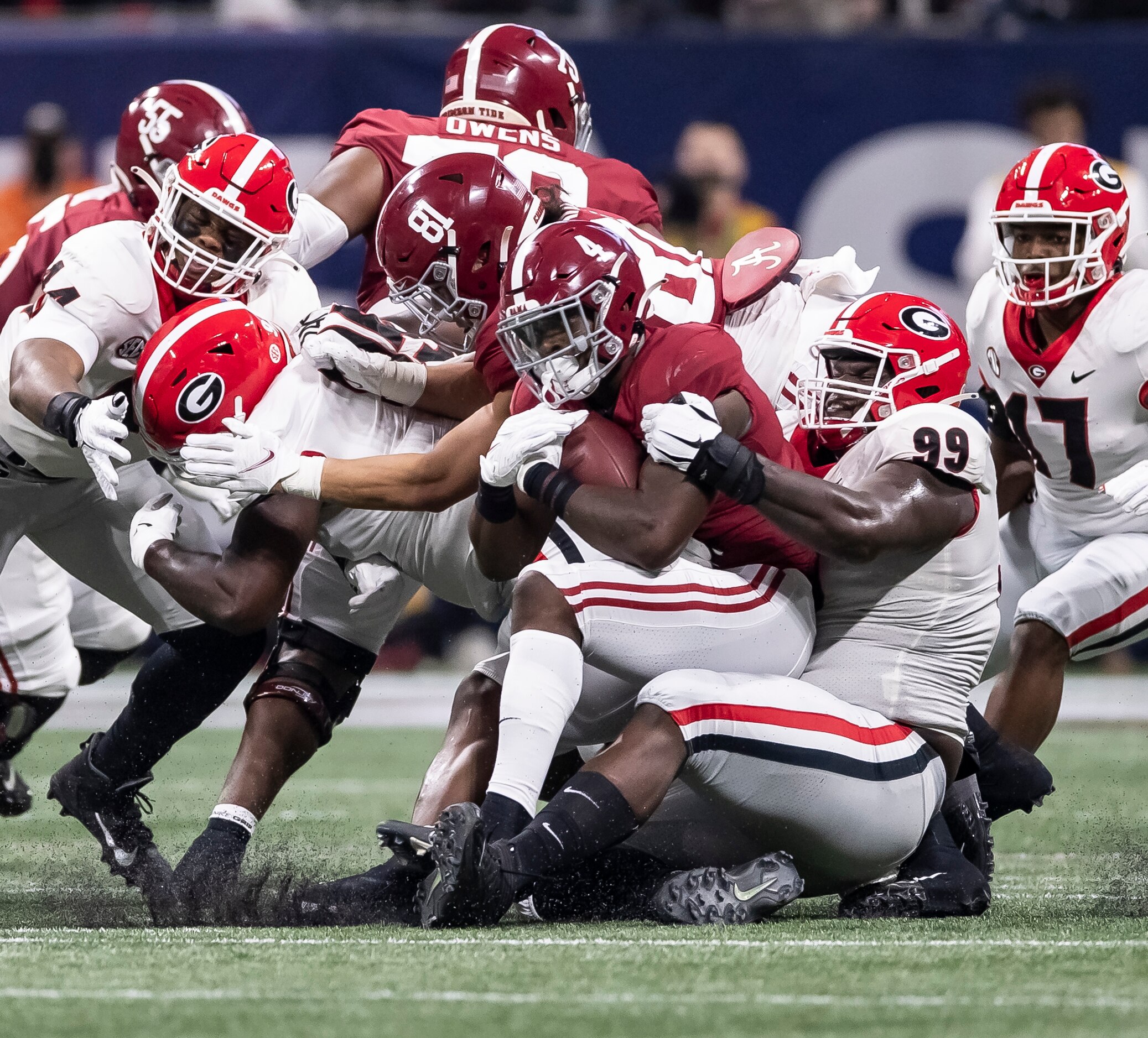 ATLANTA, GA - DECEMBER 4: Brian Robinson Jr. #4 of the Alabama Crimson Tide is tackled by Jordan Davis #99 of the Georgia Bulldogs during a game between Georgia Bulldogs and Alabama Crimson Tide at Mercedes-Benz Stadium on December 4, 2021 in Atlanta, Georgia. (Photo by Steven Limentani/ISI Photos/Getty Images)