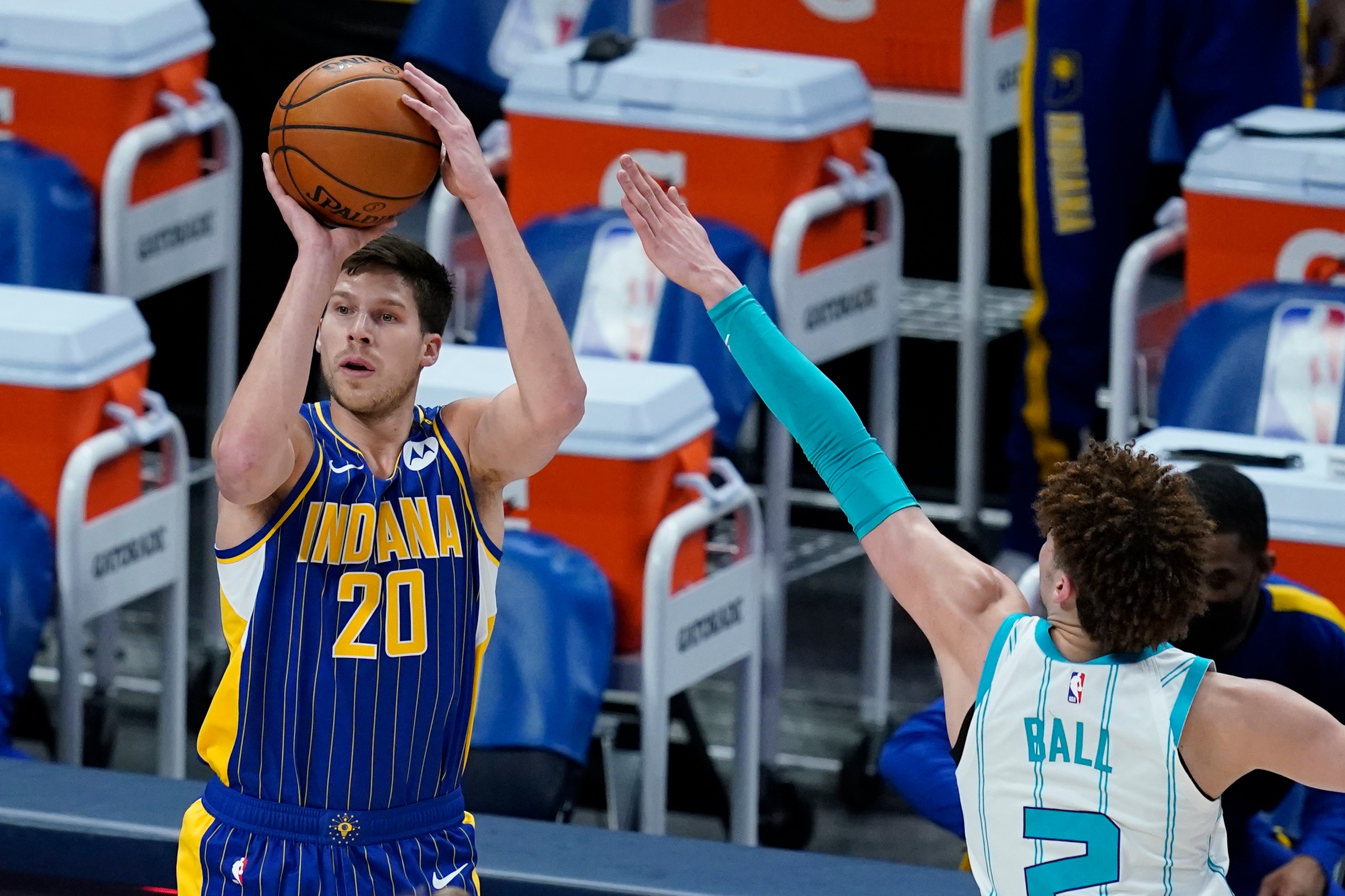 Indiana Pacers' Doug McDermott (20) shoots against Charlotte Hornets' LaMelo Ball (2) during the first half of an NBA basketball Eastern Conference play-in game Tuesday, May 18, 2021, in Indianapolis. (AP Photo/Darron Cummings)