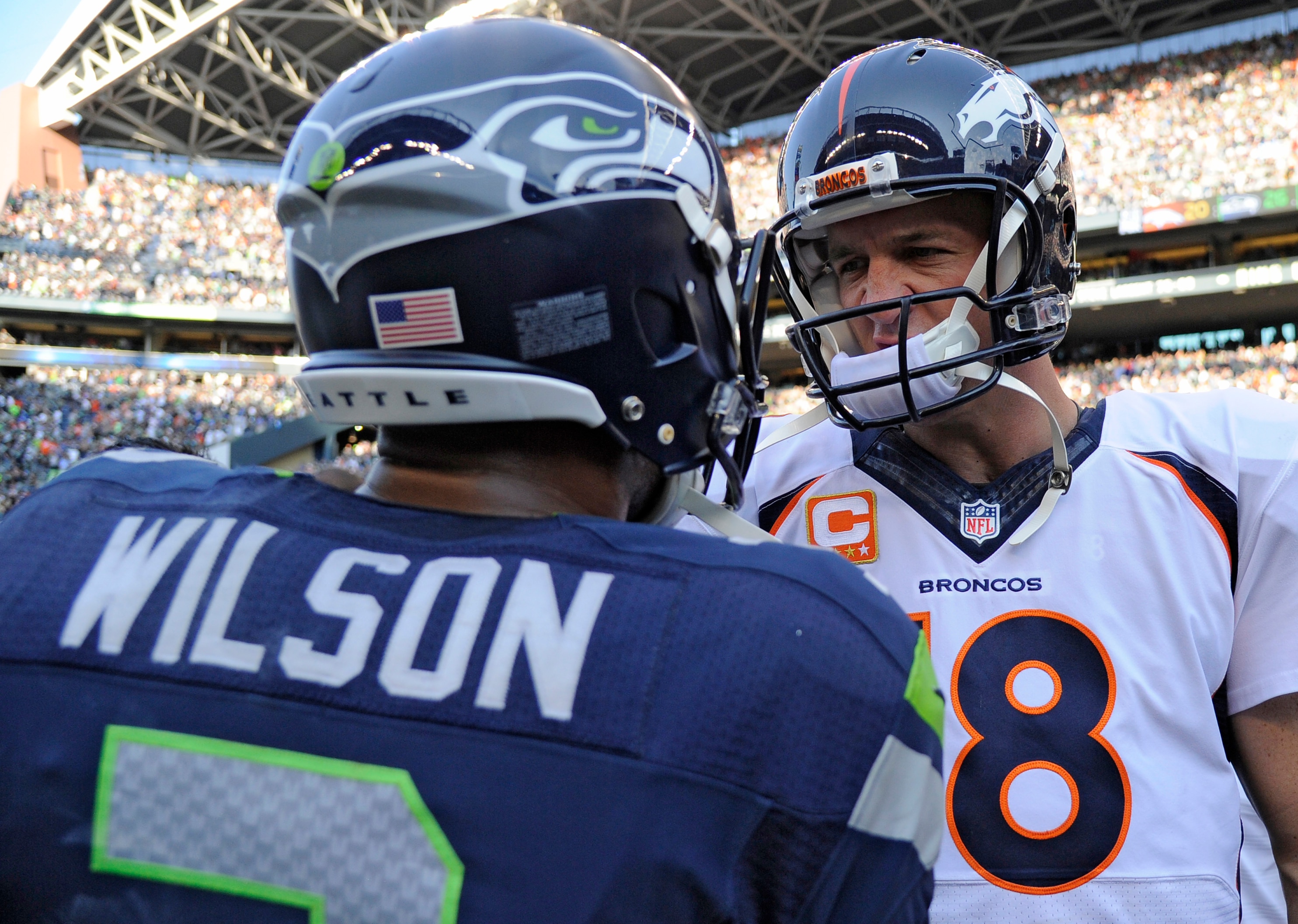 SEATTLE, WA - SEPTEMBER 21: Denver Broncos quarterback Peyton Manning (18) shakes hands with Seattle Seahawks quarterback Russell Wilson (3) after the overtime win 26-20 September 21, 2014 at CenturyLink Stadium. (Photo by John Leyba/The Denver Post via Getty Images)
