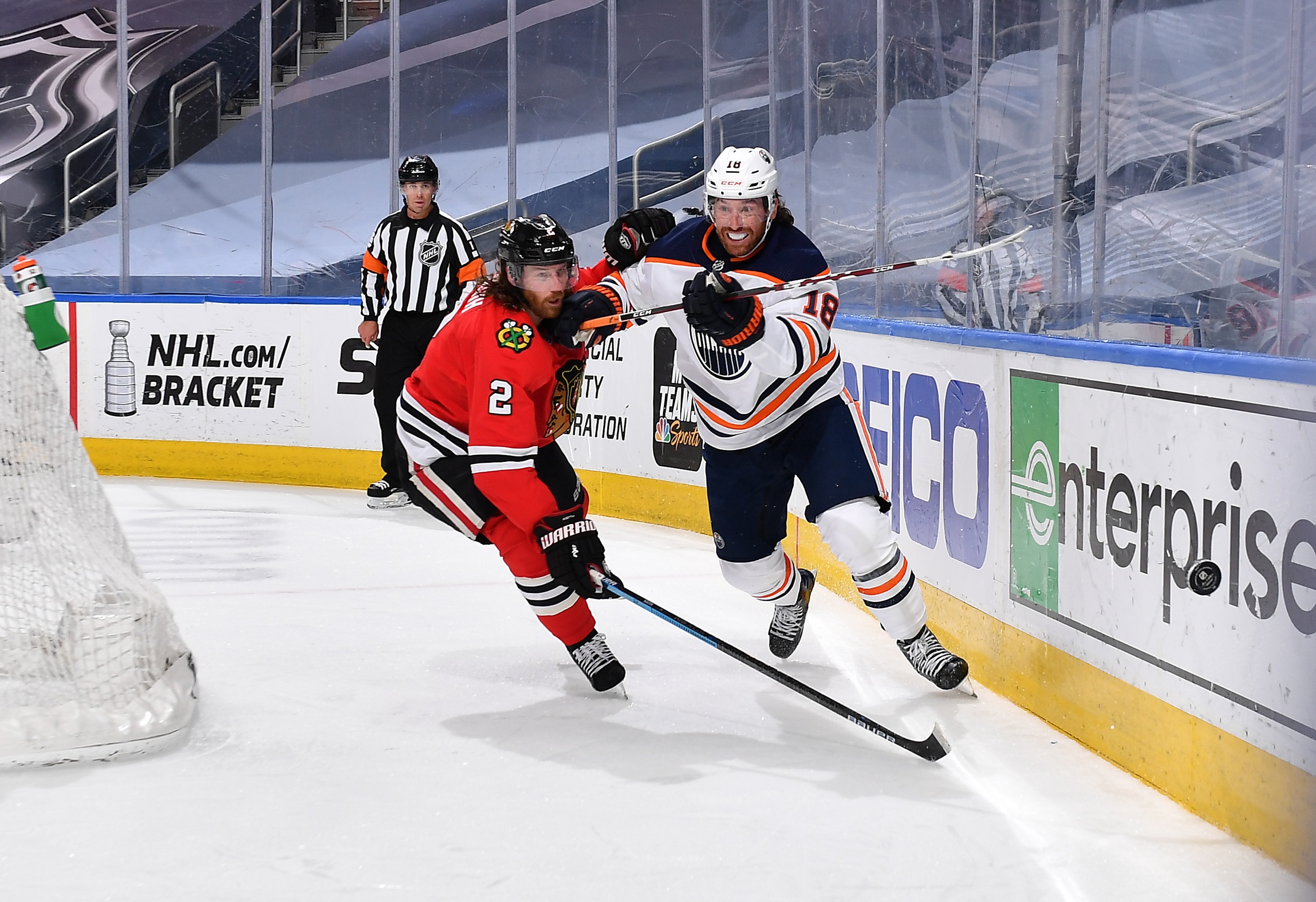 EDMONTON, ALBERTA - AUGUST 07: James Neal #18 of the Edmonton Oilers and Duncan Keith #2 of the Chicago Blackhawks skate after the puck in the second period of Game Four of the Western Conference Qualification Round at Rogers Place on August 07, 2020 in Edmonton, Alberta. (Photo by Andy Devlin/NHLI via Getty Images)