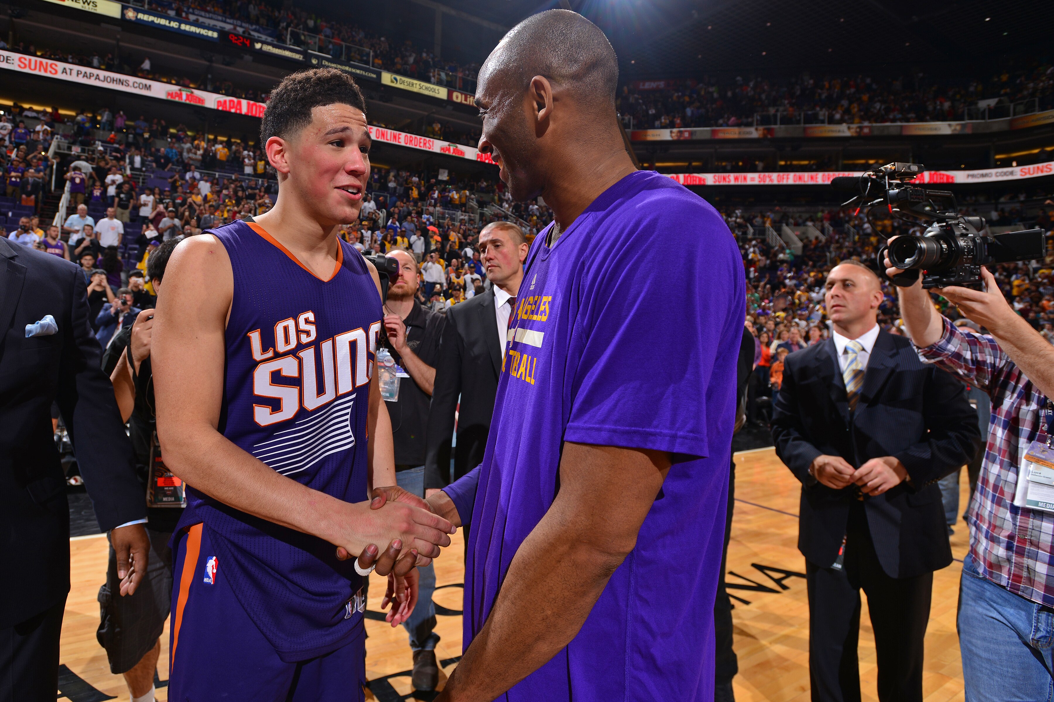 PHOENIX, AZ - MARCH 23:  Devin Booker #1 of the Phoenix Suns shakes hands with Kobe Bryant #24 of the Los Angeles Lakers after the game at Talking Stick Resort Arena on March 23, 2016 in Phoenix Arizona. NOTE TO USER: User expressly acknowledges and agrees that, by downloading and/or using this Photograph, user is consenting to the terms and conditions of the Getty Images License Agreement. Mandatory Copyright Notice: Copyright 2016 NBAE (Photo by Barry Gossage/NBAE via Getty Images)