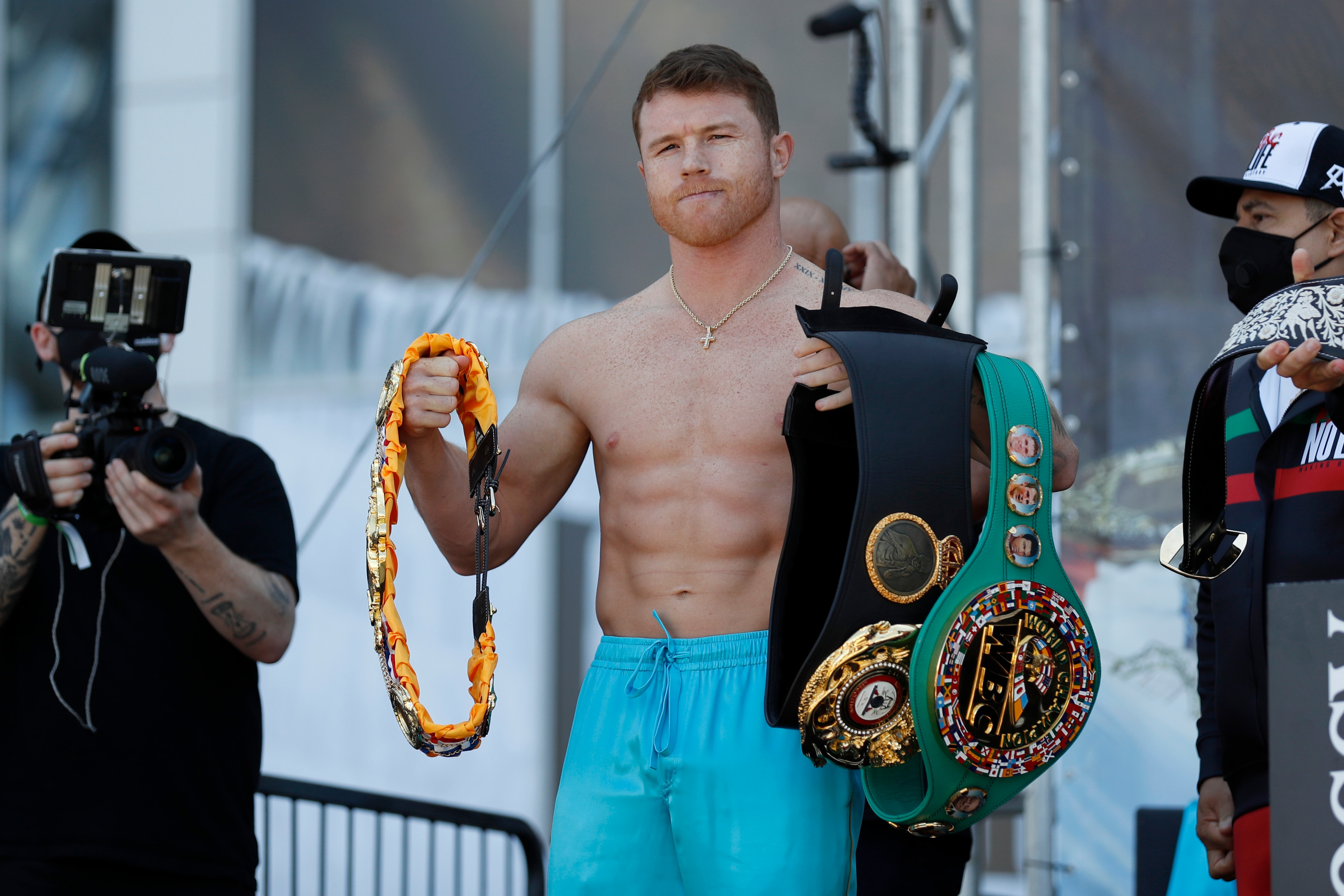 Canelo Alvarez poses for photos with his championship belts after his weigh-in for his title match against Billy Joe Saunders, Friday, May 7, 2021, in Arlington, Texas. Alvarez and Saunders fight on Saturday, May 8, 2021, for the unified super middleweight world championship. (AP Photo/Roger Steinman)