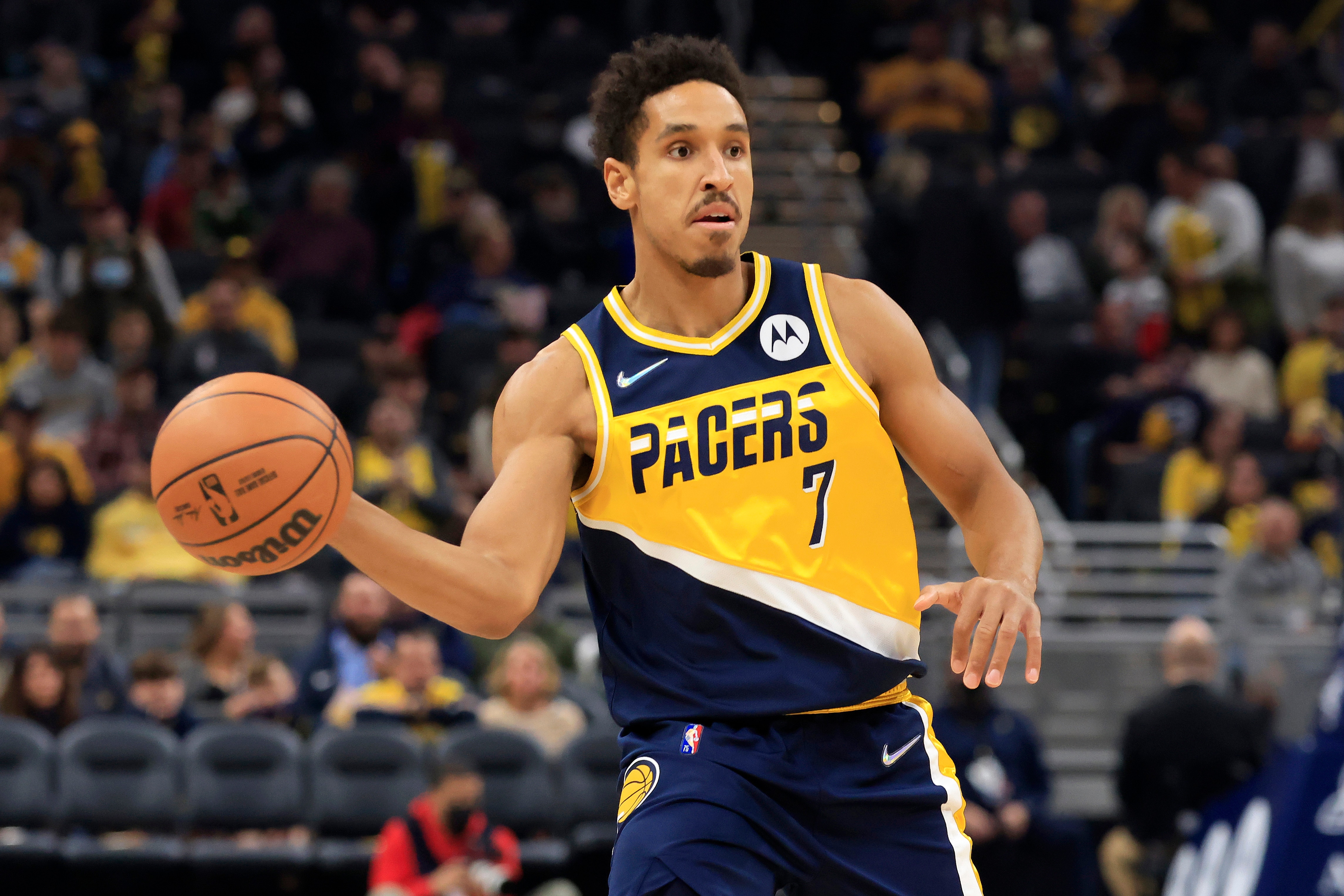 INDIANAPOLIS, INDIANA - NOVEMBER 20: Malcolm Brogdon #7 of the Indiana Pacers passes the ball in the game against the New Orleans Pelicans during the first quarter at Gainbridge Fieldhouse on November 20, 2021 in Indianapolis, Indiana. NOTE TO USER: User expressly acknowledges and agrees that,  by downloading and or using this photograph,  User is consenting to the terms and conditions of the Getty Images License Agreement. (Photo by Justin Casterline/Getty Images)