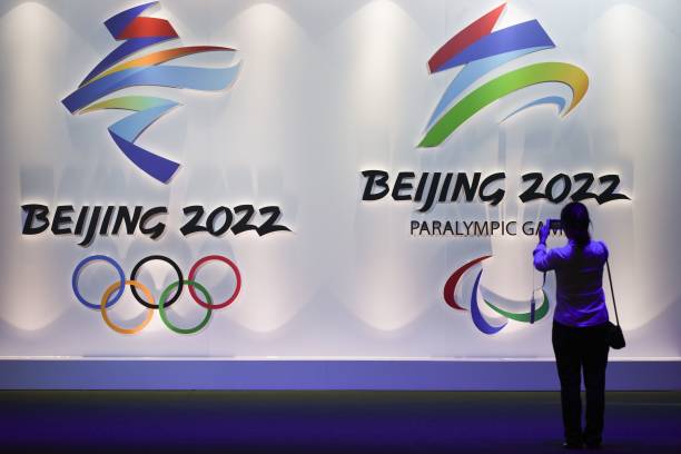 A visitor takes pictures of logos of the upcoming Beijing 2022 Winter Olympic and Paralympic Games during the Beijing Olympic Expo marking the 10th anniversary of the 2008 Olympic Games, in Beijing on August 8, 2018. (Photo by WANG ZHAO / AFP)        (Photo credit should read WANG ZHAO/AFP via Getty Images)