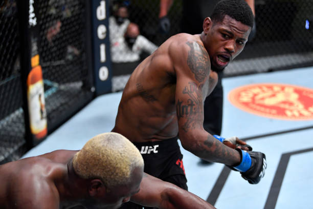 LAS VEGAS, NEVADA - MARCH 20: (R-L) Kevin Holland punches Derek Brunson in their middleweight fight during the UFC Fight Night event at UFC APEX on March 20, 2021 in Las Vegas, Nevada. (Photo by Chris Unger/Zuffa LLC via Getty Images)