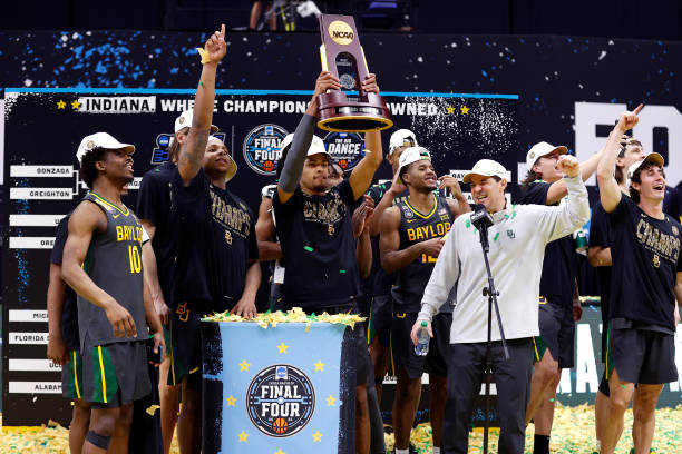 INDIANAPOLIS, INDIANA - APRIL 05: MaCio Teague #31 of the Baylor Bears holds up the trophy after defeating the Gonzaga Bulldogs 86-70 in the National Championship game of the 2021 NCAA Men's Basketball Tournament at Lucas Oil Stadium on April 05, 2021 in Indianapolis, Indiana. (Photo by Jamie Squire/Getty Images)