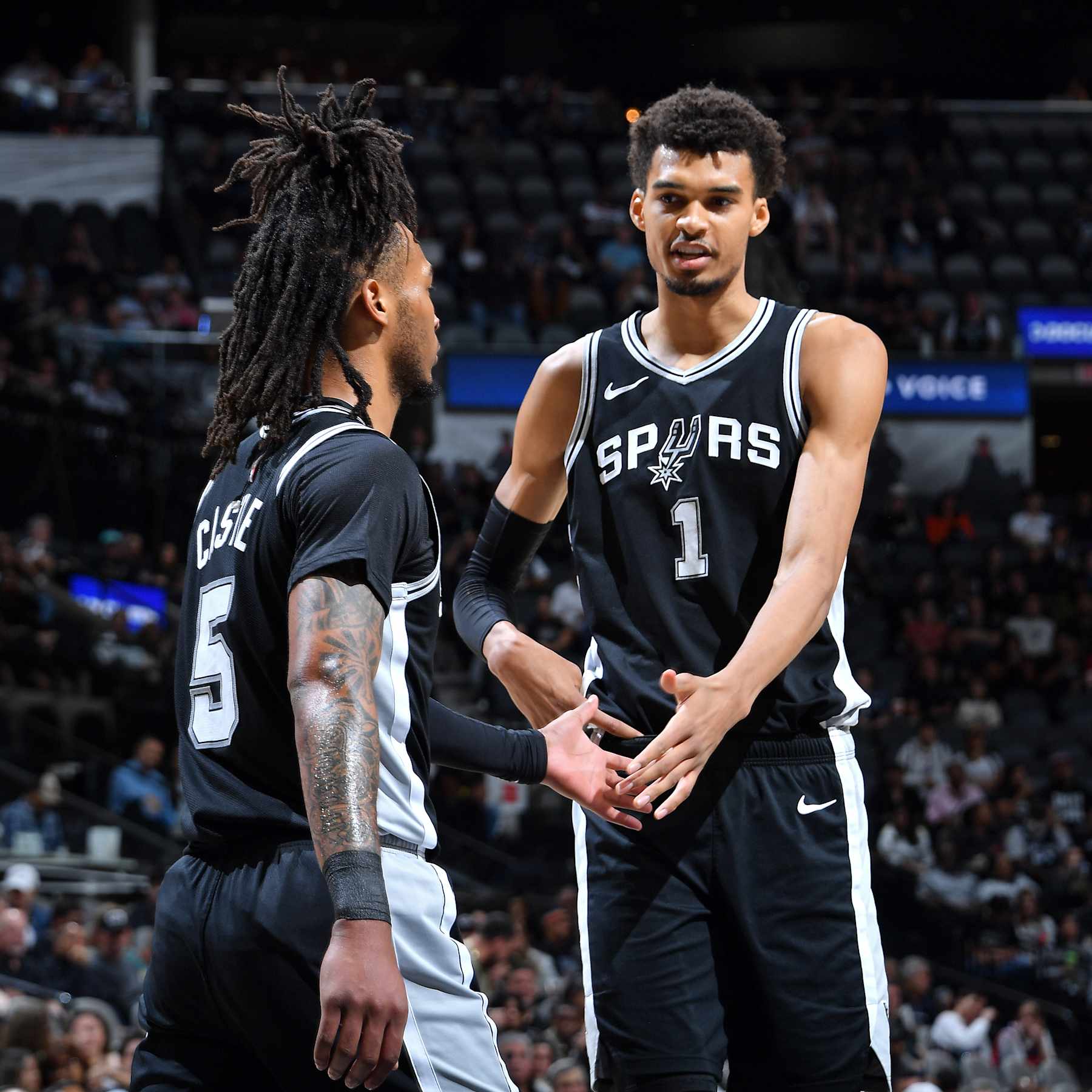 SAN ANTONIO, TX - NOVEMBER 13: Victor Wembanyama #1 and Stephon Castle #5 of the San Antonio Spurs high five during the game against the Washington Wizards on November 13, 2024 at the Frost Bank Center in San Antonio, Texas. NOTE TO USER: User expressly acknowledges and agrees that, by downloading and or using this photograph, user is consenting to the terms and conditions of the Getty Images License Agreement. Mandatory Copyright Notice: Copyright 2024 NBAE (Photos by Michael Gonzales/NBAE via Getty Images)
