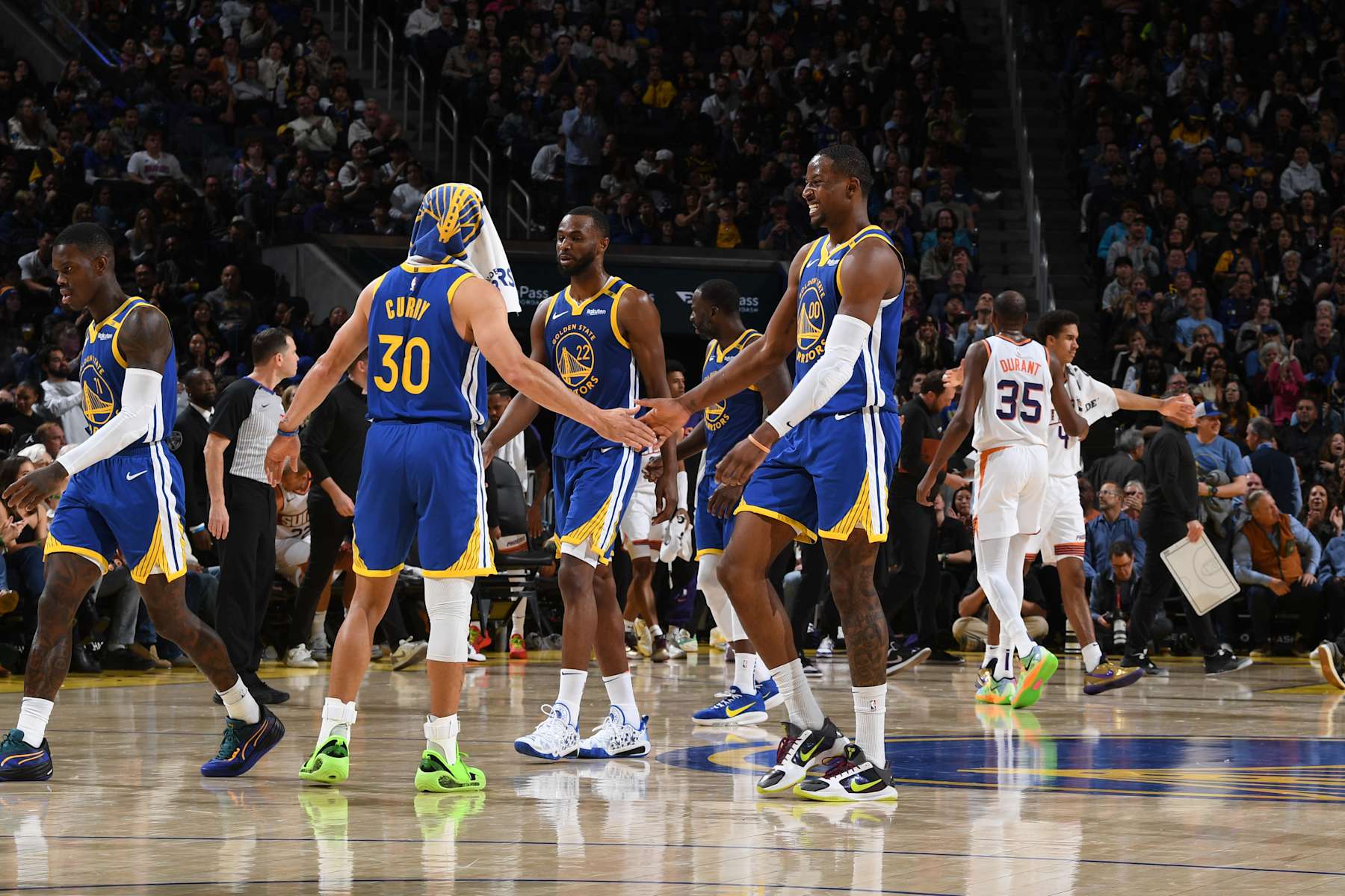 SAN FRANCISCO, CA - DECEMBER 28: Stephen Curry #30 high fives Jonathan Kuminga #00 of the Golden State Warriors during the game against the Phoenix Suns on December 28, 2024 at Chase Center in San Francisco, California. NOTE TO USER: User expressly acknowledges and agrees that, by downloading and or using this photograph, user is consenting to the terms and conditions of Getty Images License Agreement. Mandatory Copyright Notice: Copyright 2024 NBAE (Photo by Noah Graham/NBAE via Getty Images)