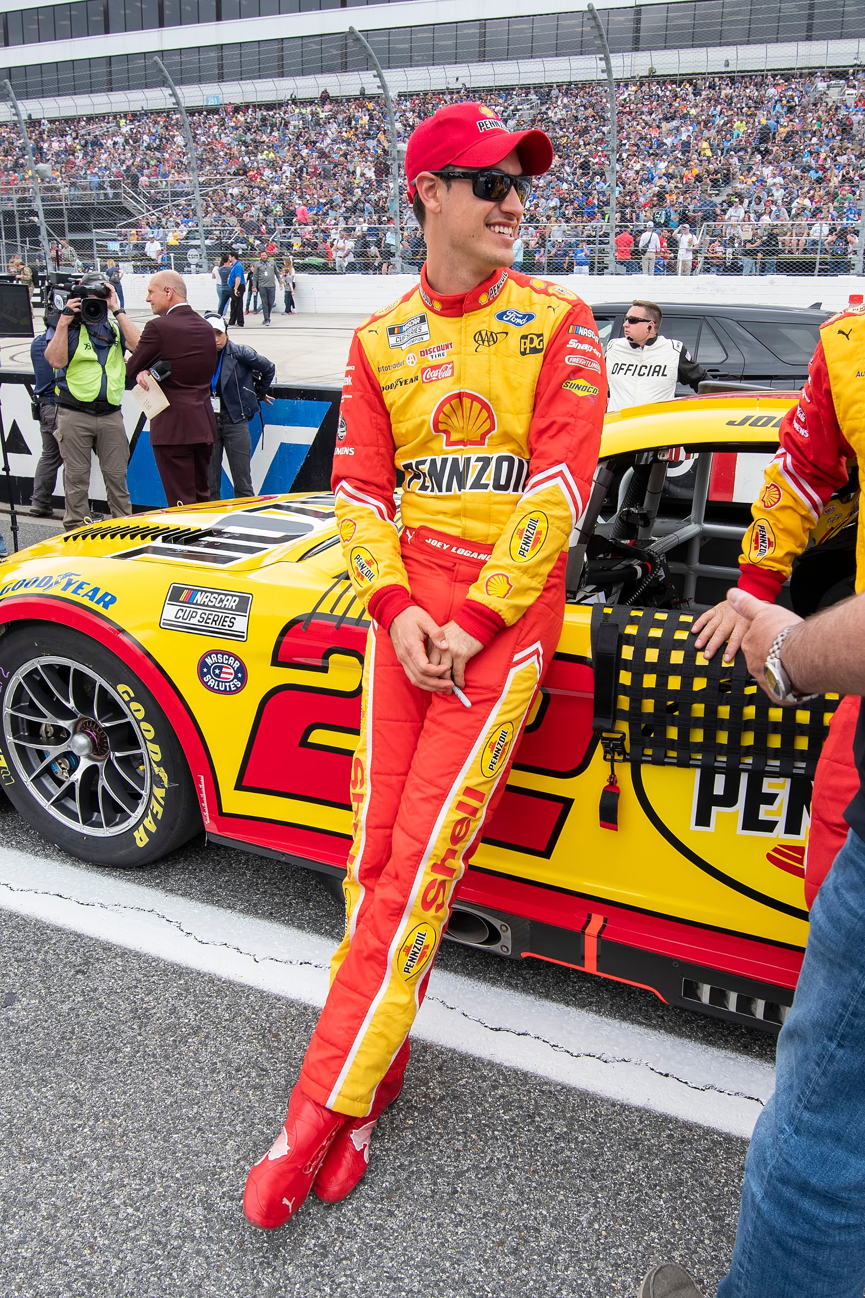 Joey Logano (22) leans on his car before NASCAR Cup Series auto race at Dover Motor Speedway, Sunday, May 1, 2022, in Dover, Del. (AP Photo/Jason Minto)